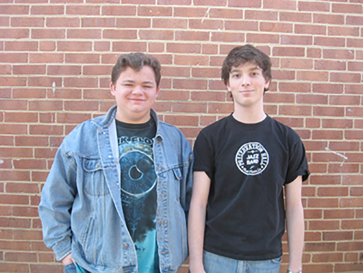 3rd Place winner team photo of two male teens standing in front of a brick wall.