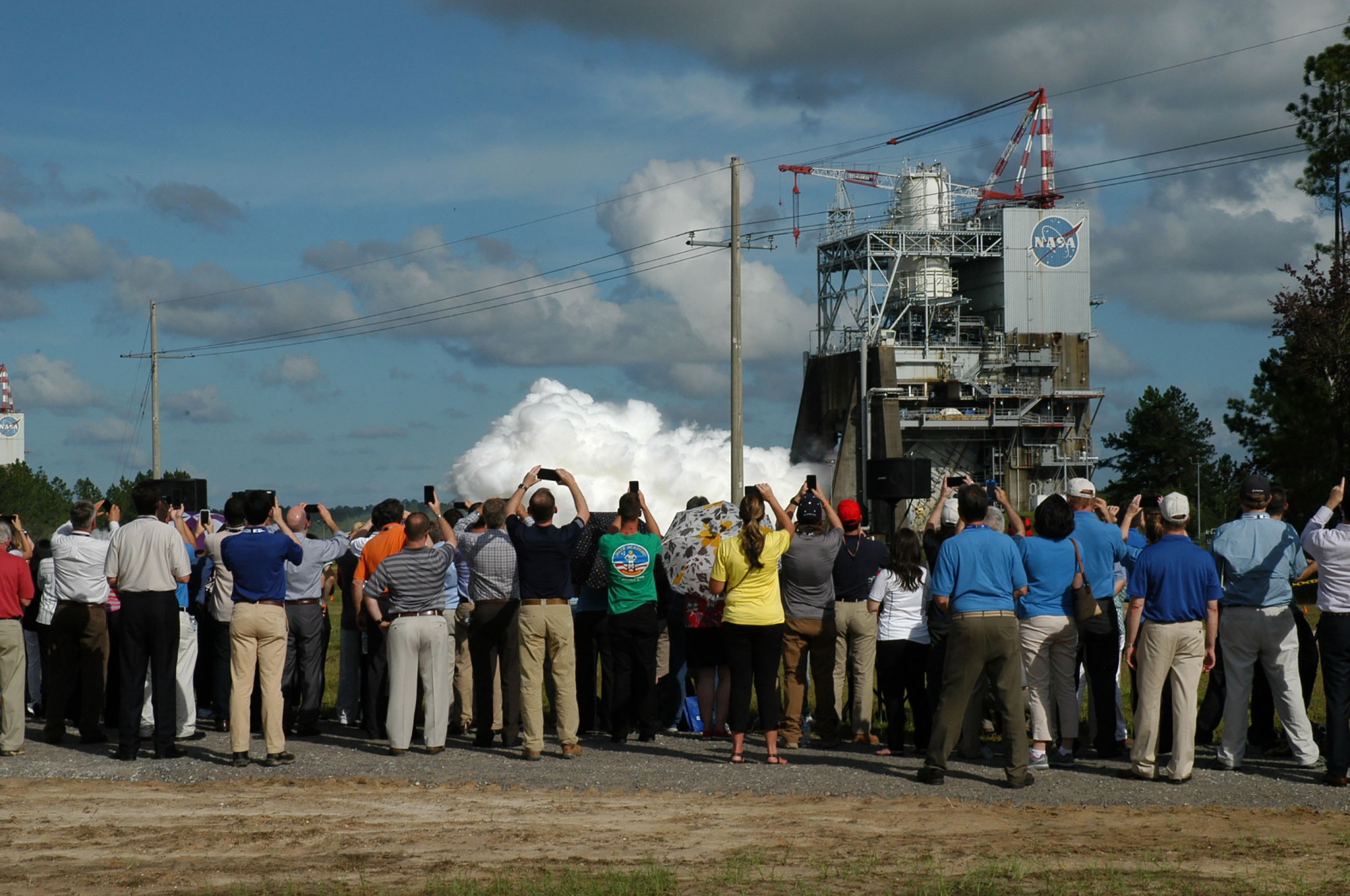 A crowd watches as the SLS RS-25 engine roars to life for a 420-second test on the A-1 test stand at Stennis.