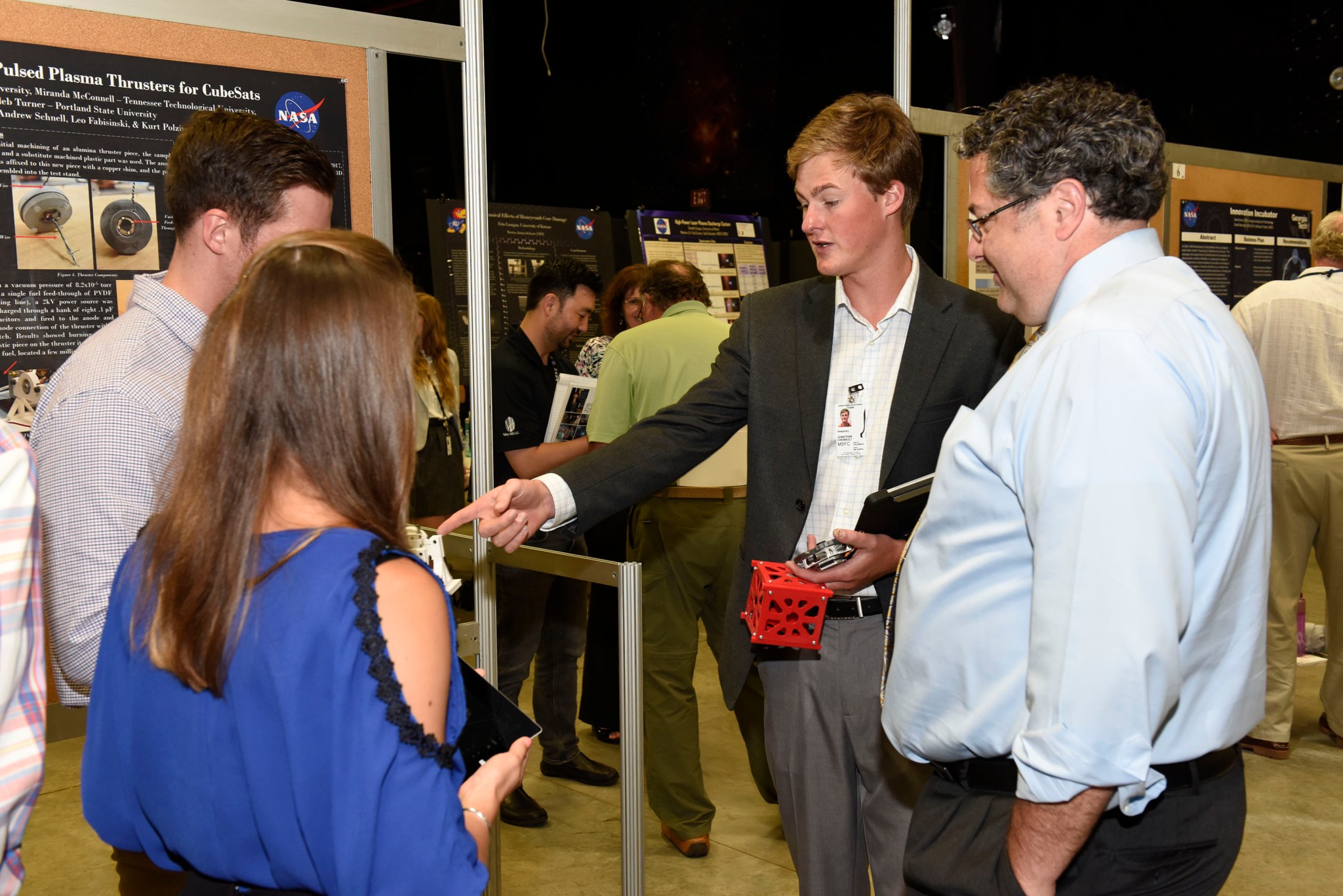 Marshall Center Director Todd May learns about the summer research of Jonathan Chenault, Miranda McConnell and Caleb Turner. 