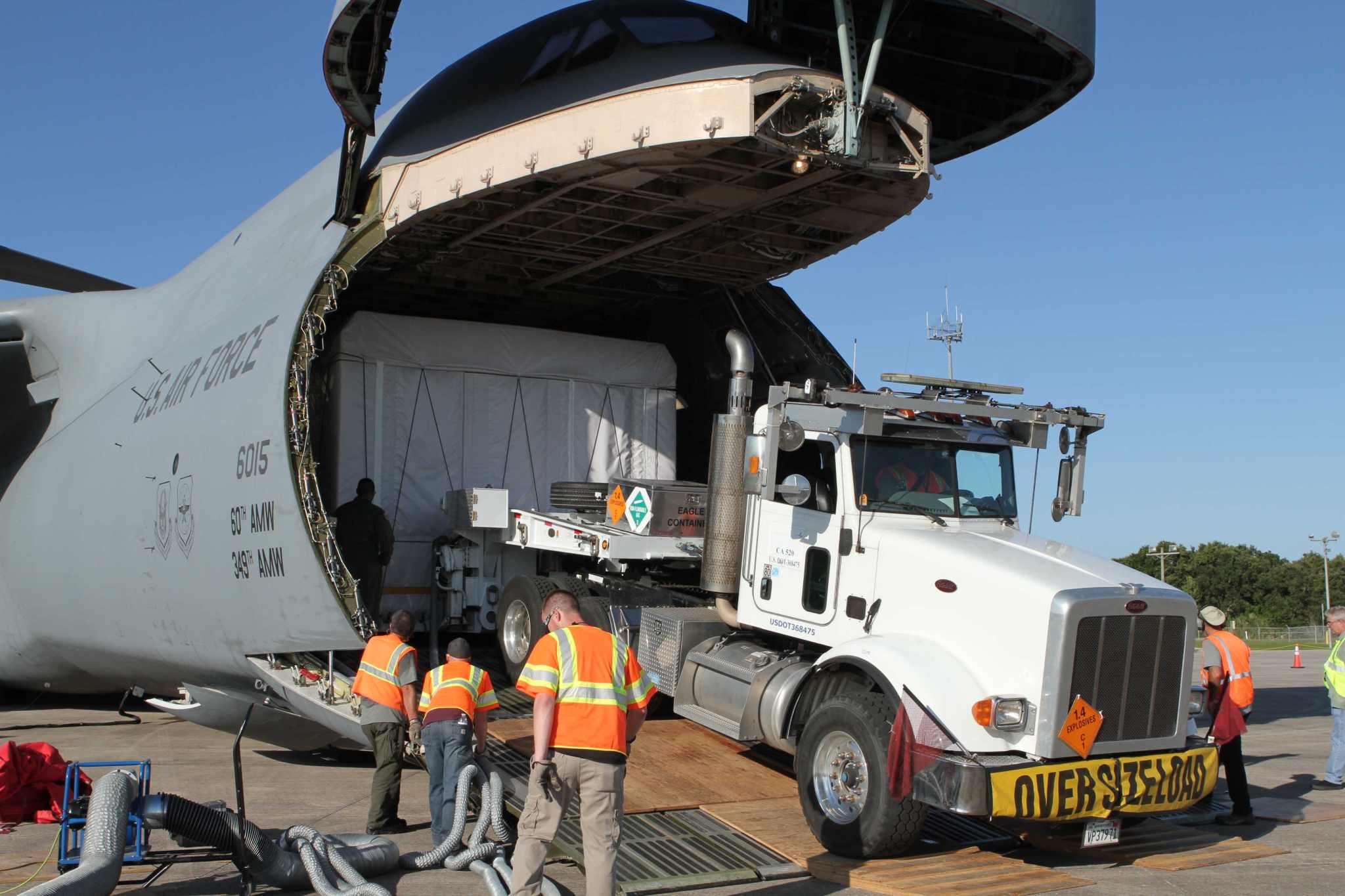 Truck backs into airplane to get box