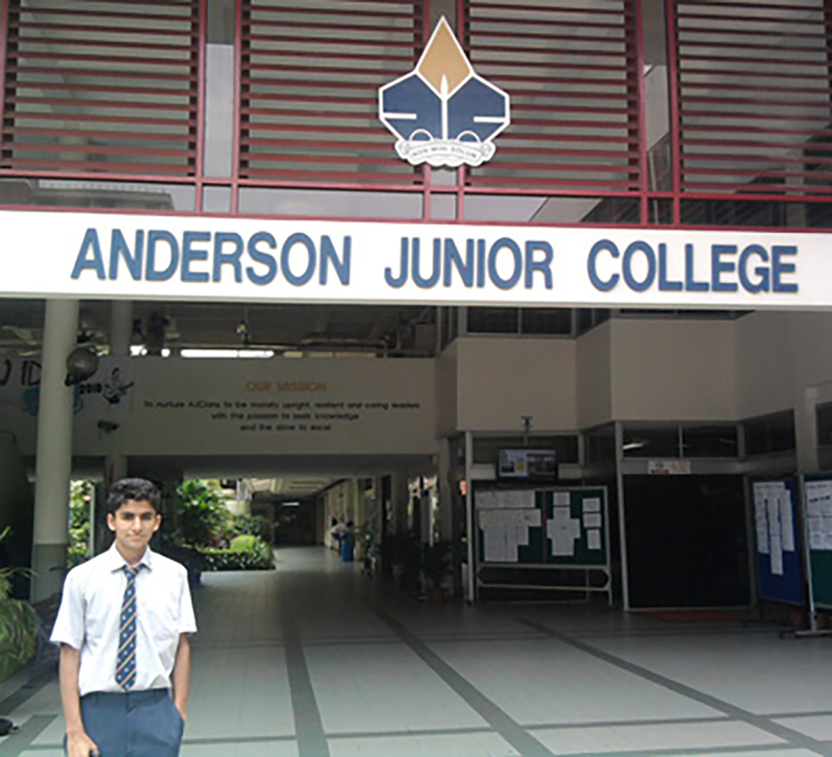 International 1st place individual winner standing in front of his school.