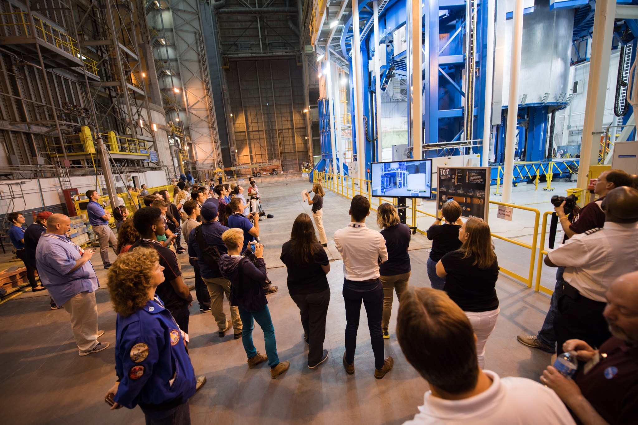 A group gets a closer look at the world's largest welding tool, the Vertical Assembly Center, during a tour of Michoud.