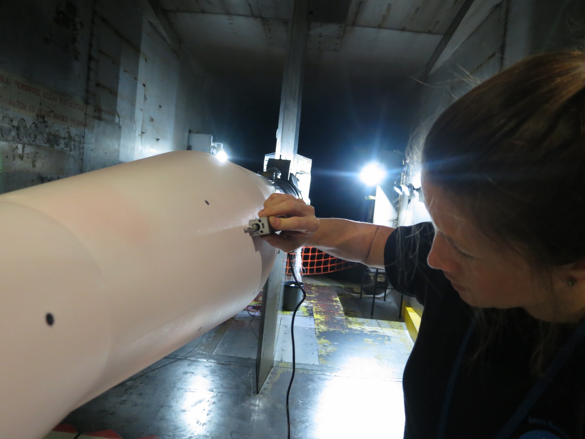 NASA engineer Nettie Roozeboom measures levels of roughness on a launch vehicle model.