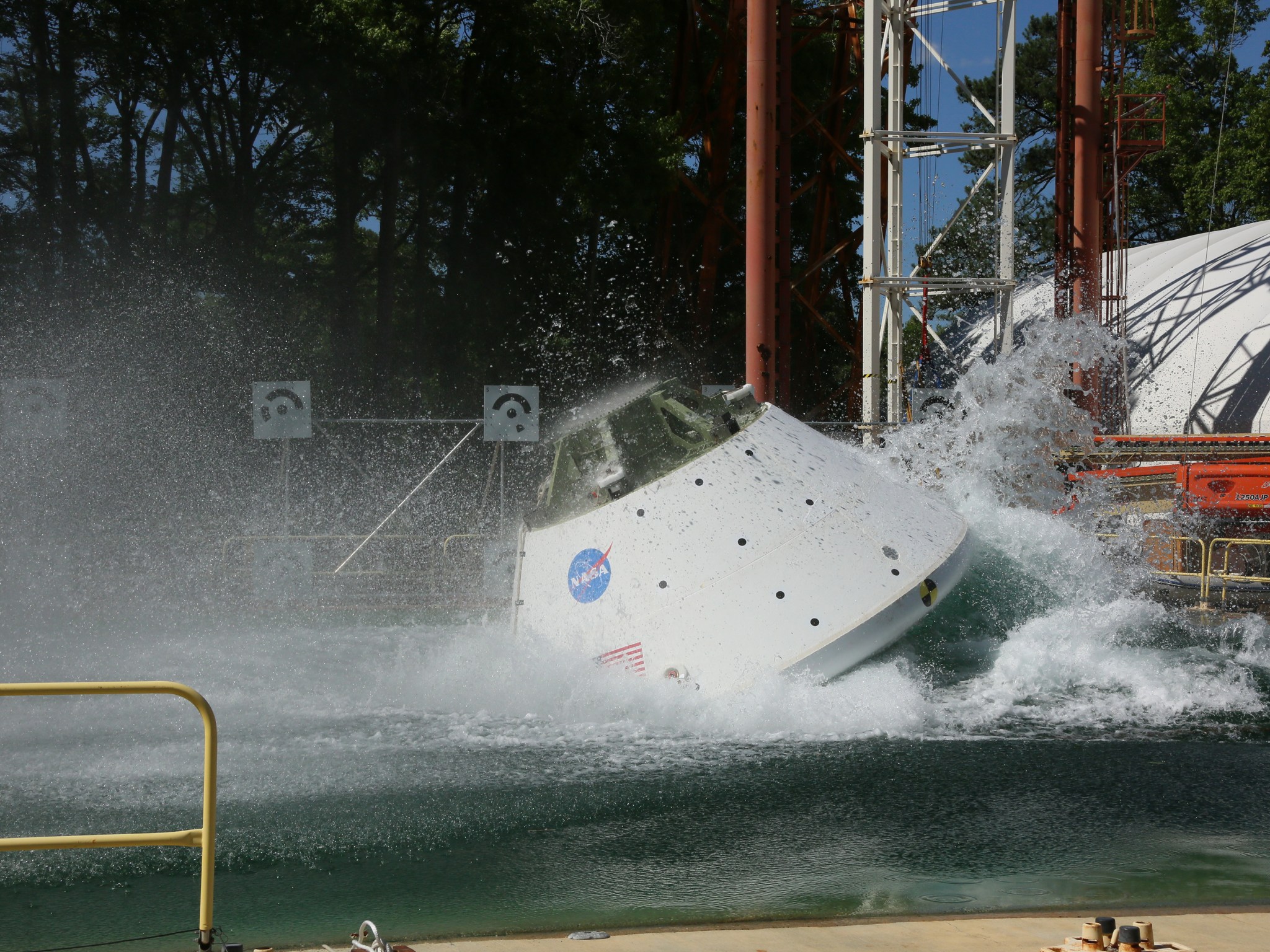 Engineers drop an Orion test capsule into the 20-feet-deep Hydro Impact Basin at NASA’s Langley Research Center in Hampton, Va