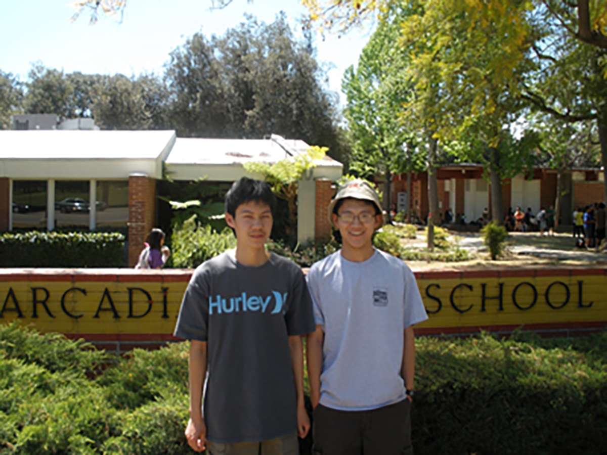Jason Jong and Ziang Xie standing in front of Arcadia High School.