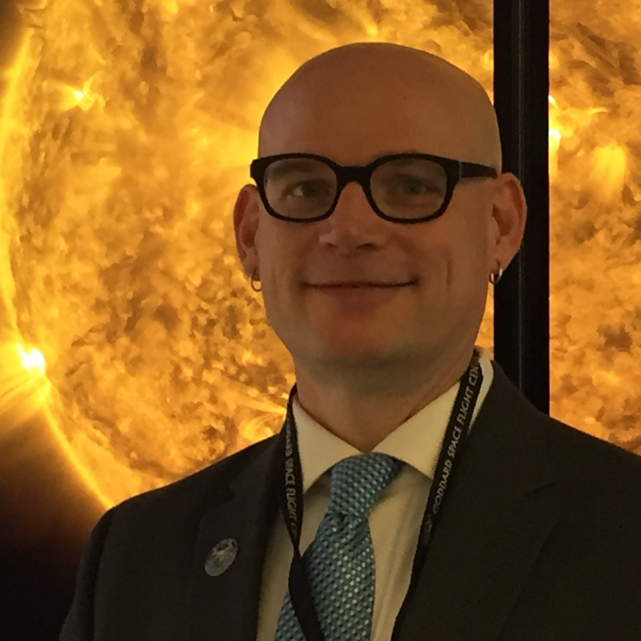 portrait in front of image of sun