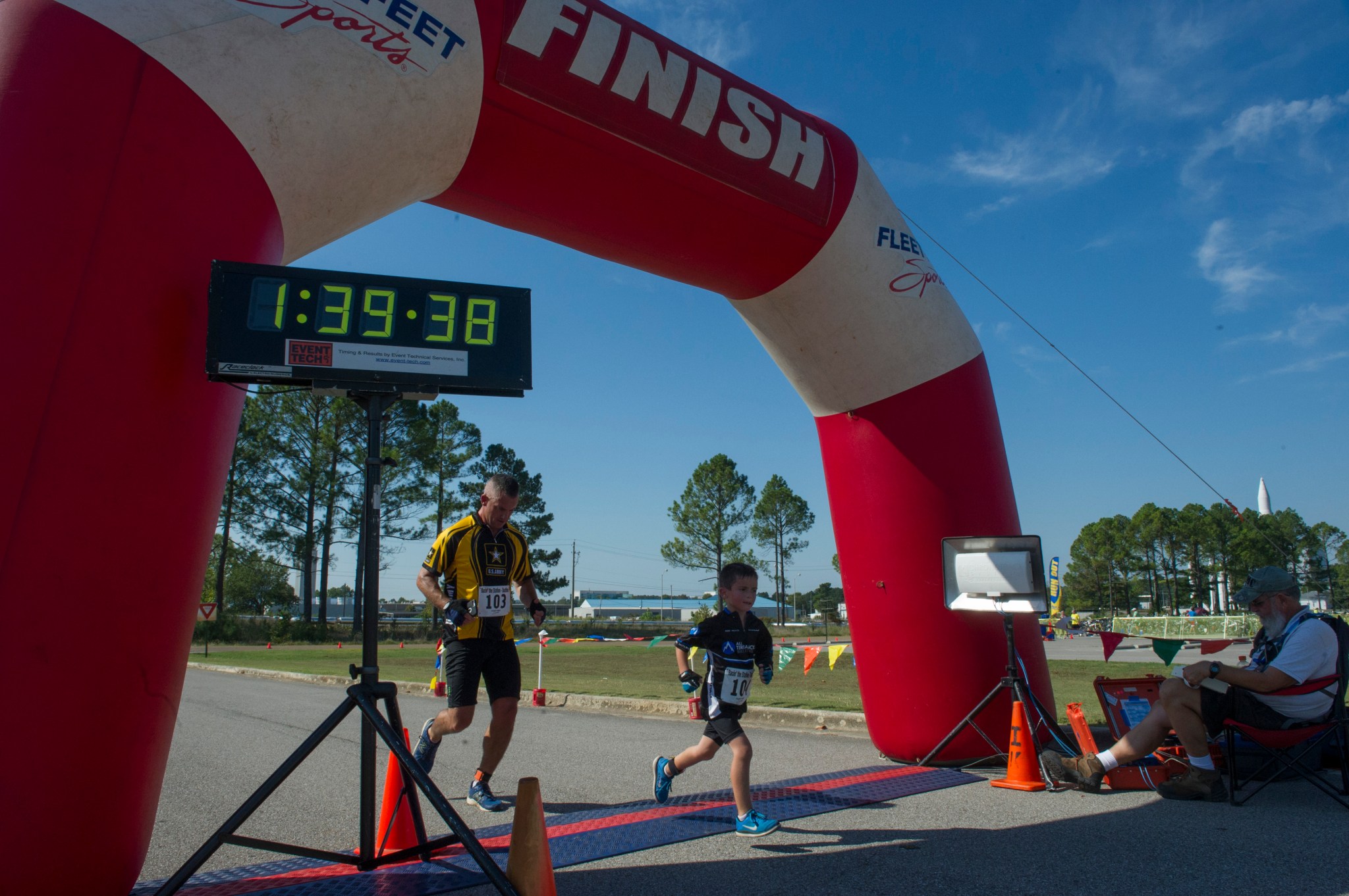 Six-year-old Charlie Westrip crosses the finish line just ahead of his father, in the Racin' the Station duathlon Sept 24.