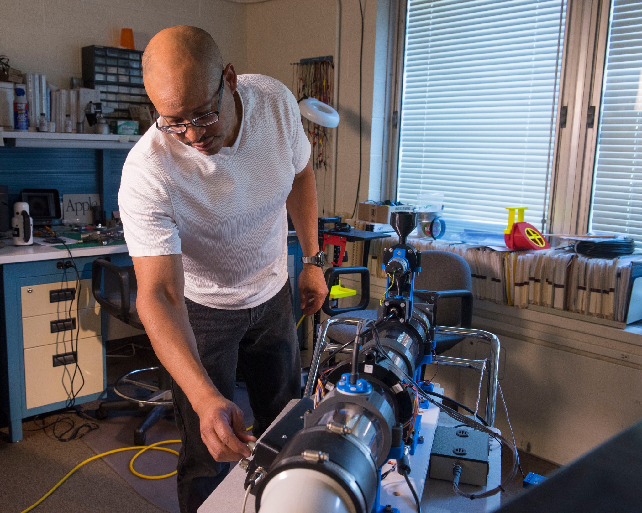 Electrical engineer Larry Greer sets up a homemade wind tunnel to test a saltation probe.