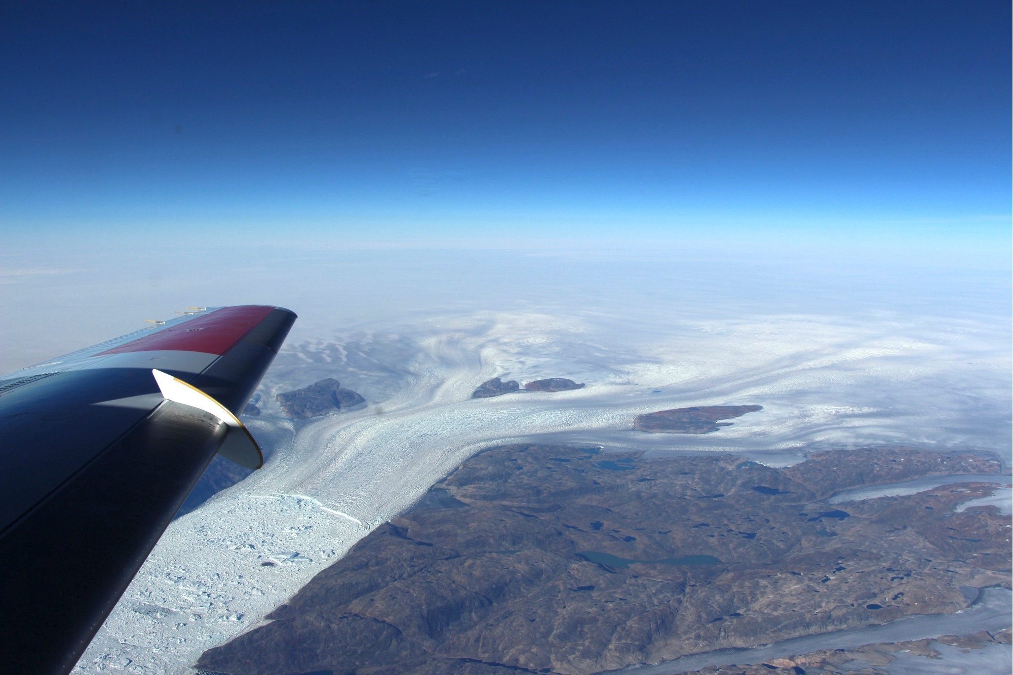 glacer seen over the wing of an airplane