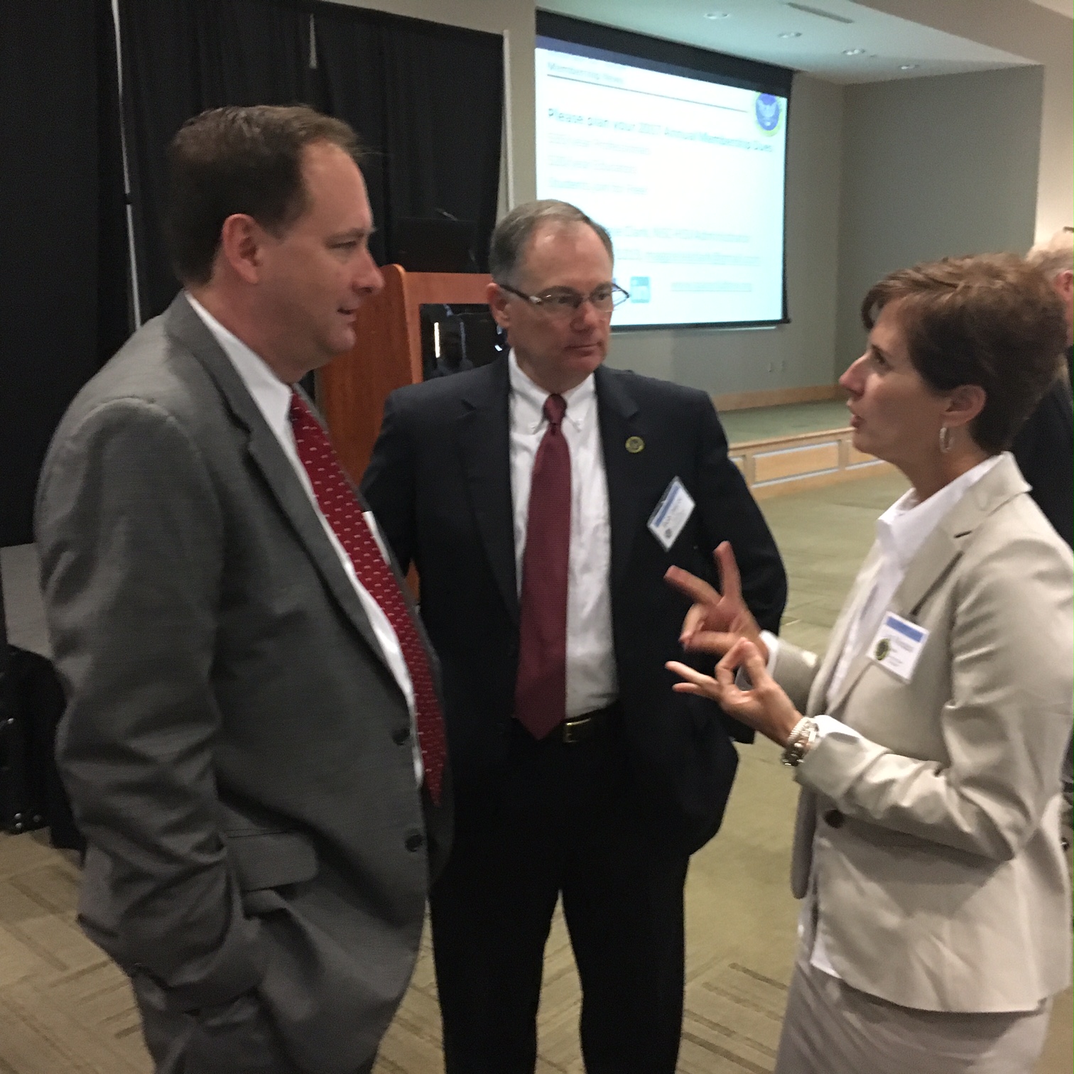 Associate Administrator Robert Lightfoot, left, talks with National Space Club-Huntsville members Bob DaLee and Lisa Monaco.