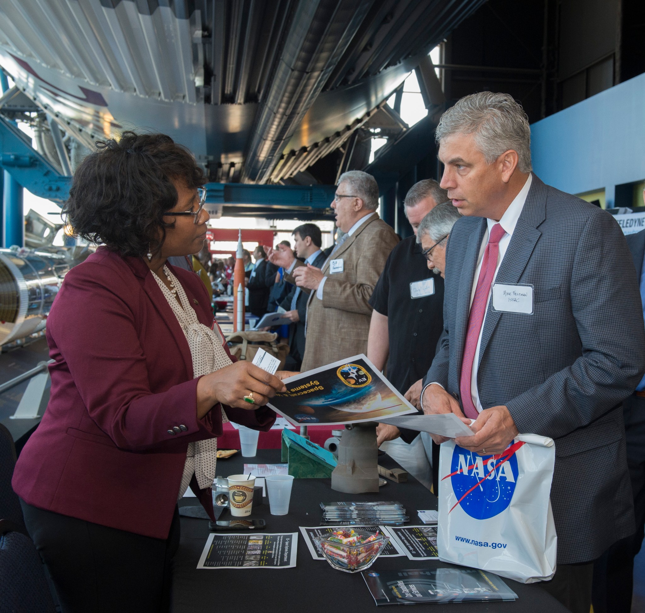 NASA Marshall team member Nadra Hatchett, left, shares information about 3D printing and propulsion research underway at NASA.