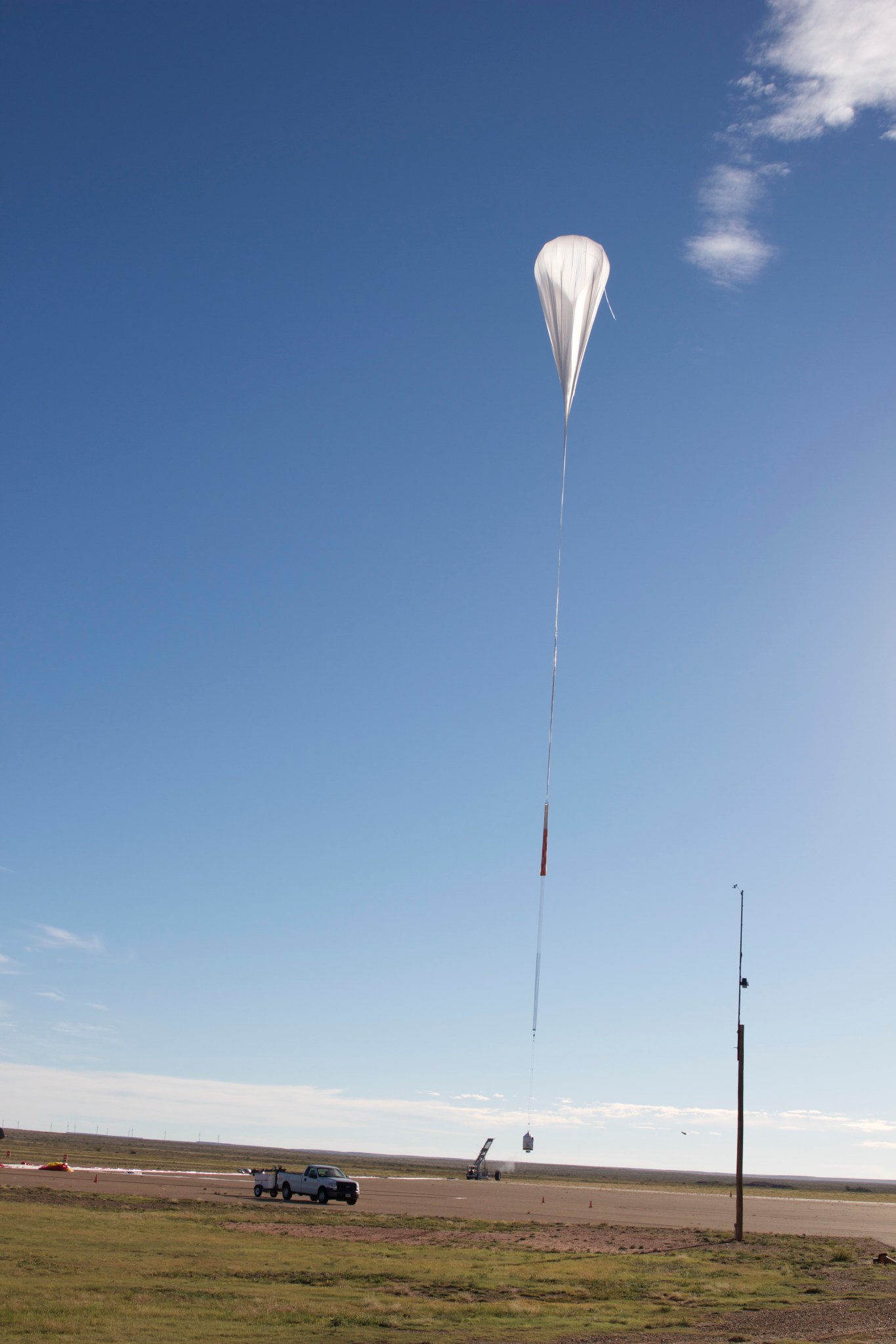 A scientific balloon is partially inflated in the air.