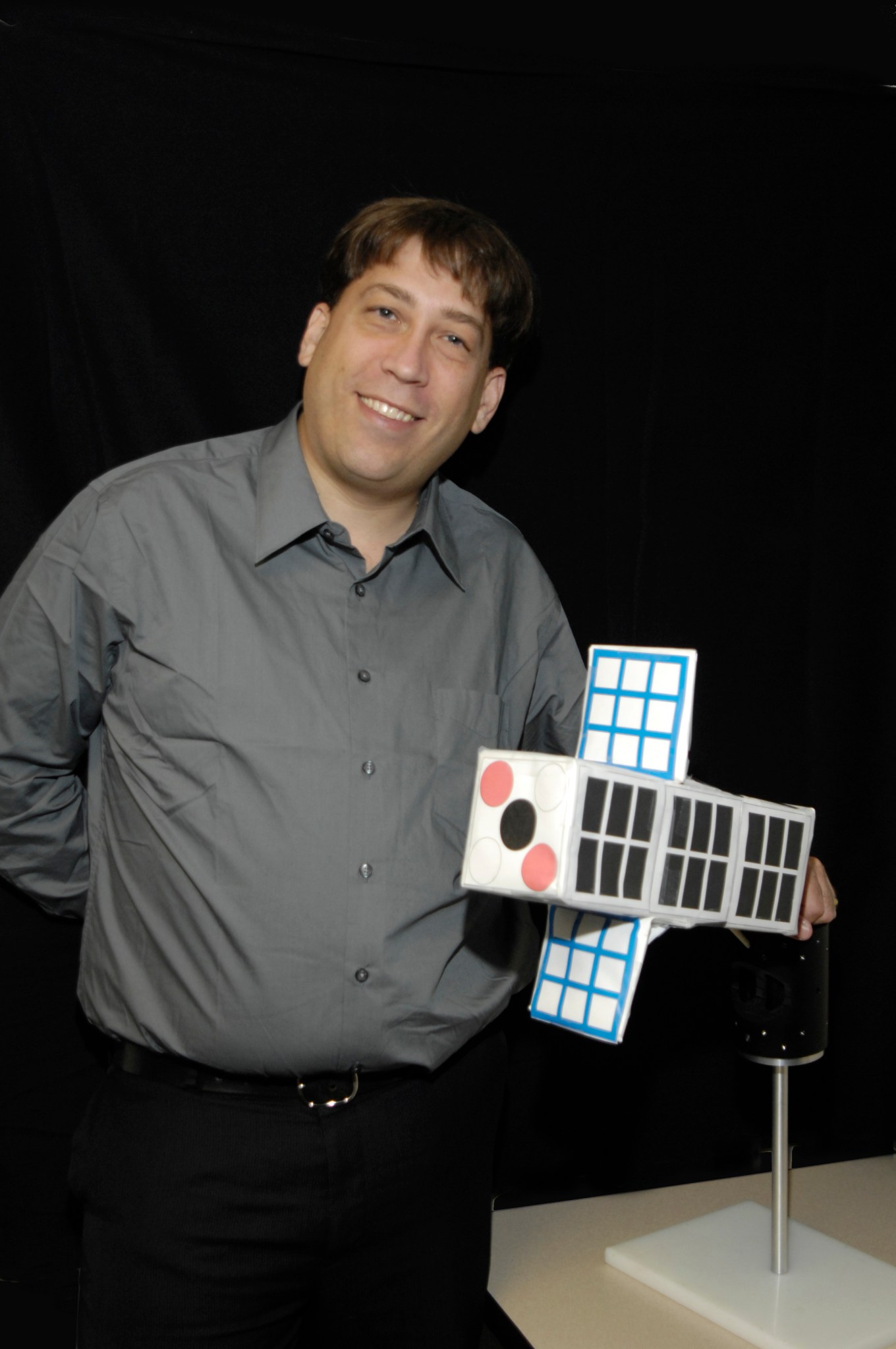 Doug Rowland with model of cubesat