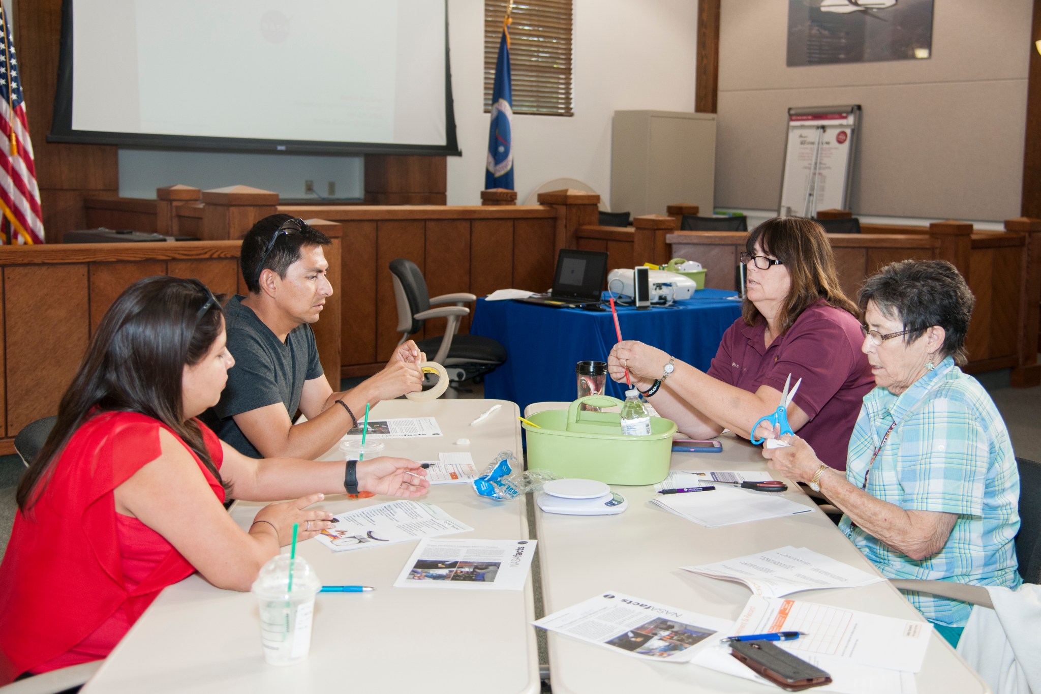 Educators construct a model of a green-propellant-based spacecraft.