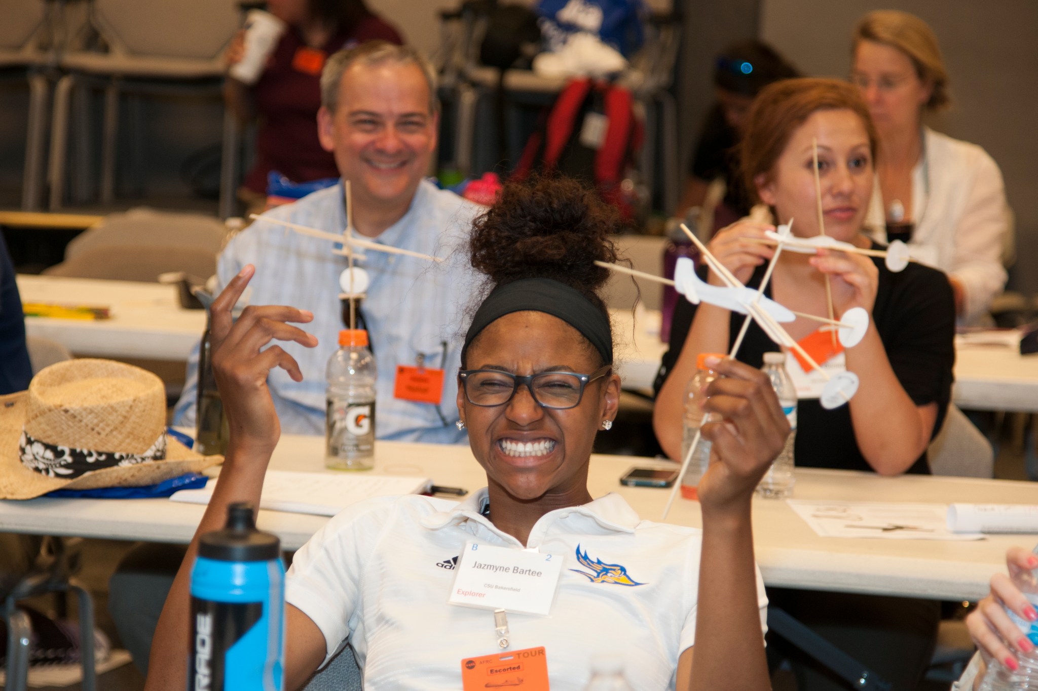 California State University student Jazmyne Bartee holds a plane she had built.