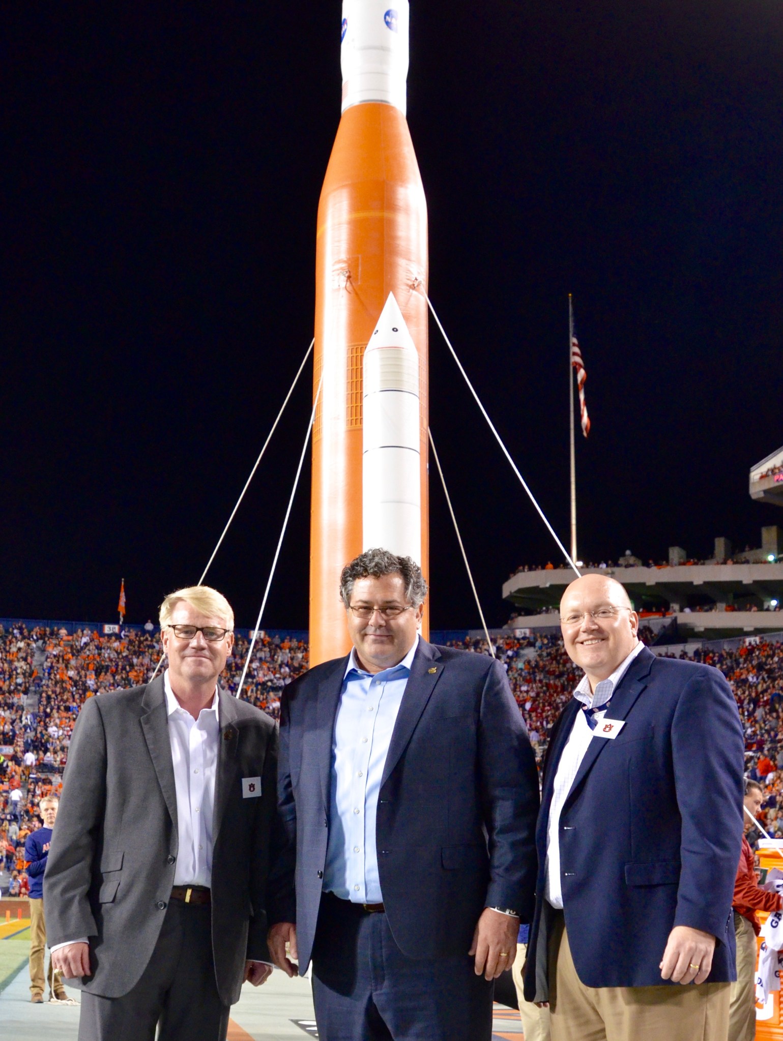 Todd May, center, Chris Roberts, right, and Mike Ogles, left, on the field for a space-themed halftime show Oct. 22.