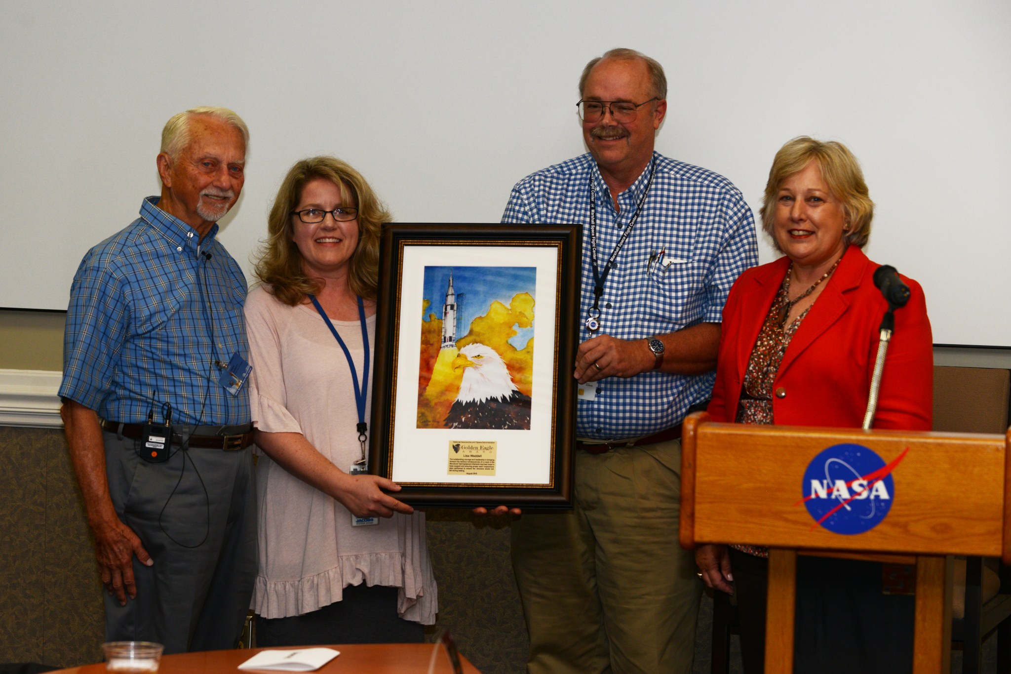 Lisa Waddell, second from left, is presented the Golden Eagle Award by SMA Director Rick Burt, second from right, and Jan Davis.