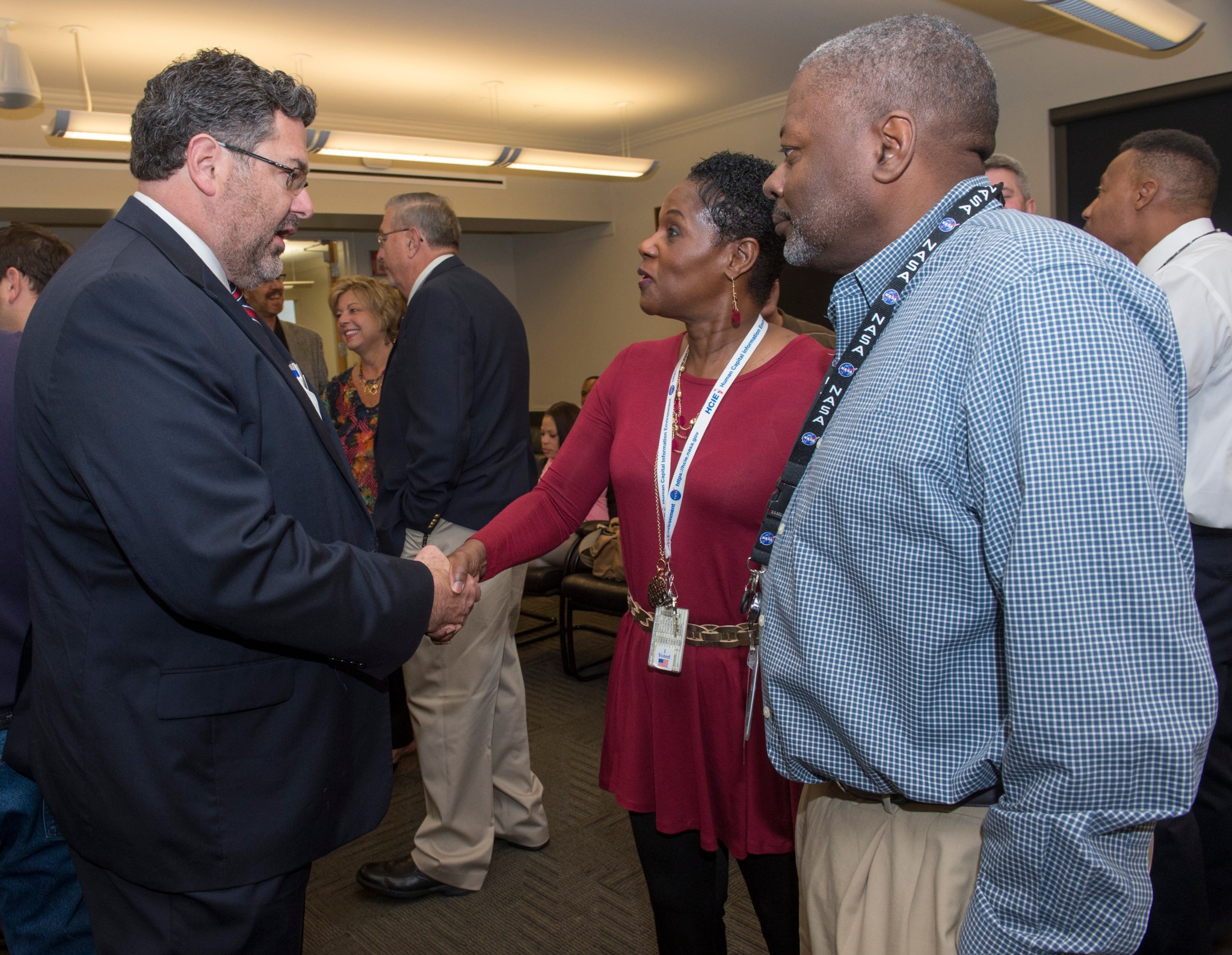 Todd May, left, chats with TyAnne Thomas, center, and Barry Kaigler during Marshall's annual Veterans Day event Nov. 9. 