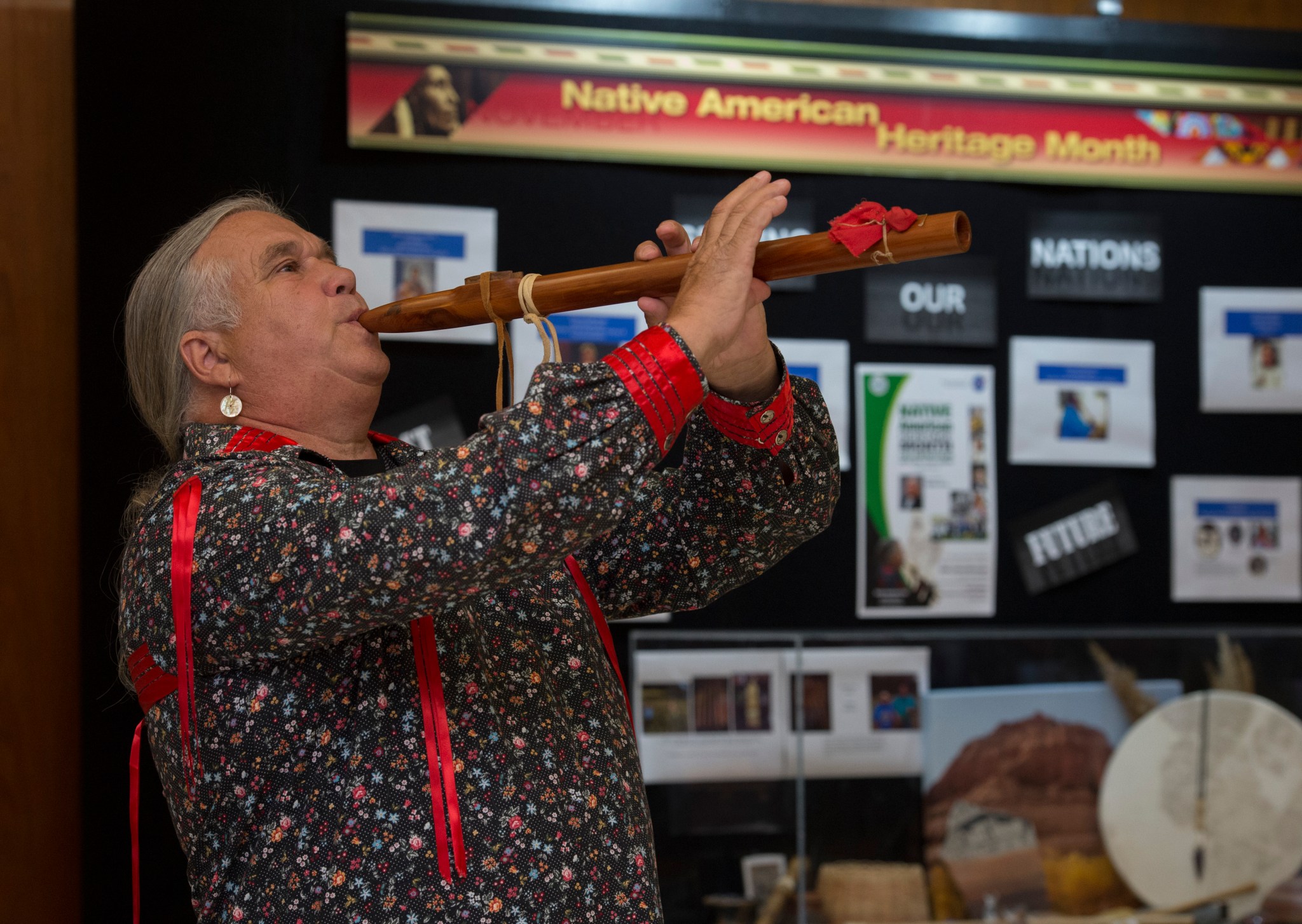 Jimmy Yellowhorse, a member of the Cherokee tribe, performs a traditional song during the Native American Heritage Month event.
