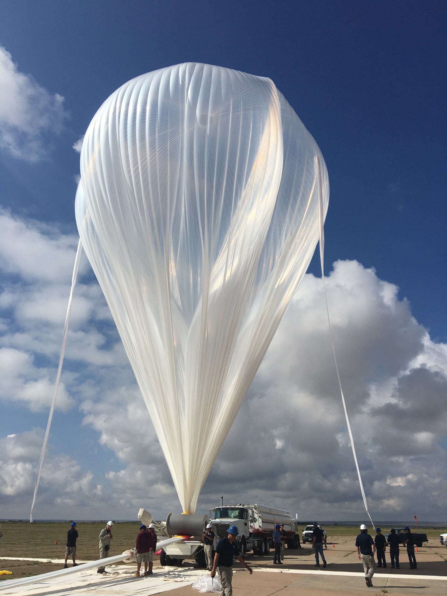 A scientific balloon partially inflated in the shape of an upside down teardrop.