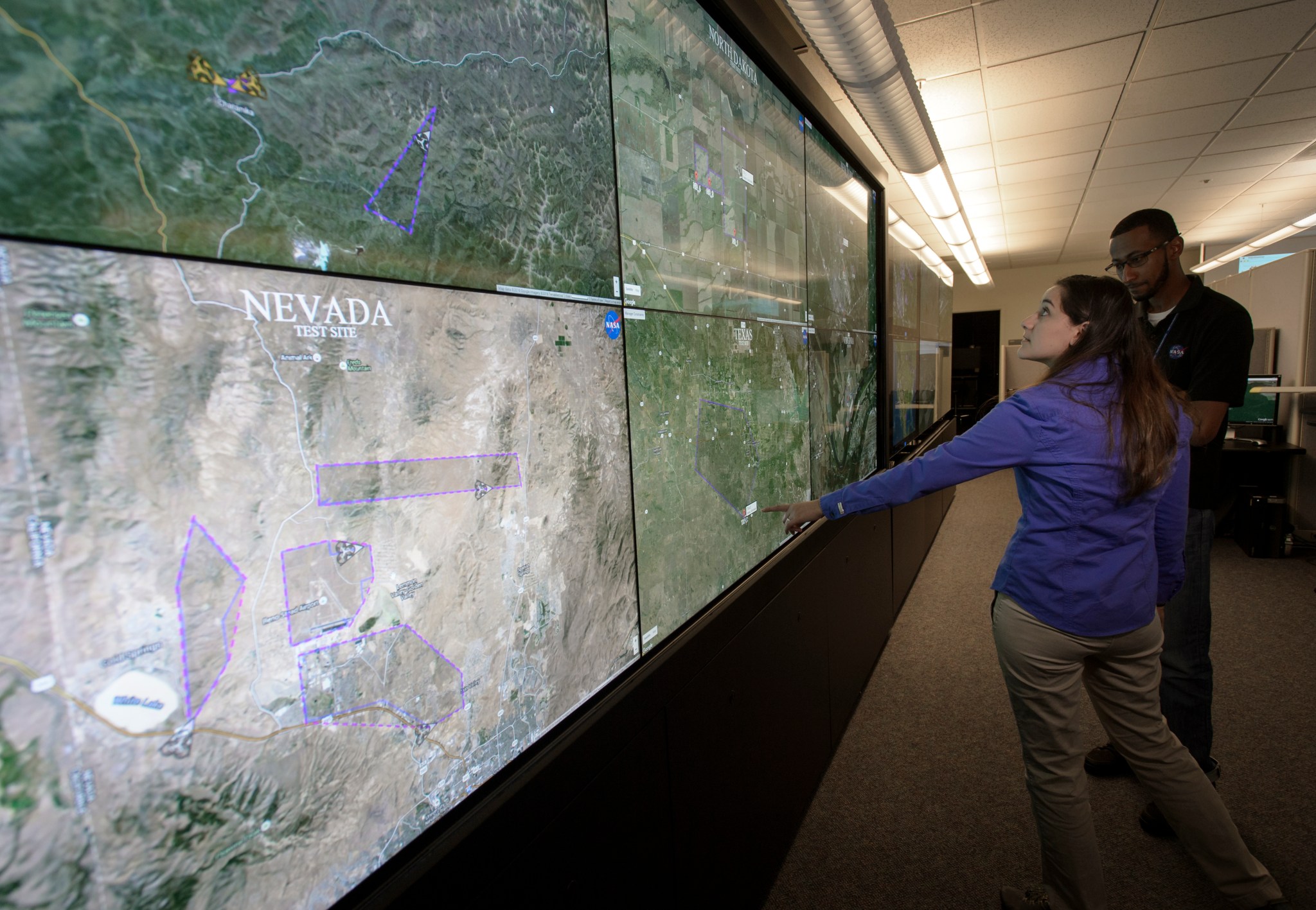 Researchers in “drone mission control” monitor the progress of drones in simultaneous flight at six test sites