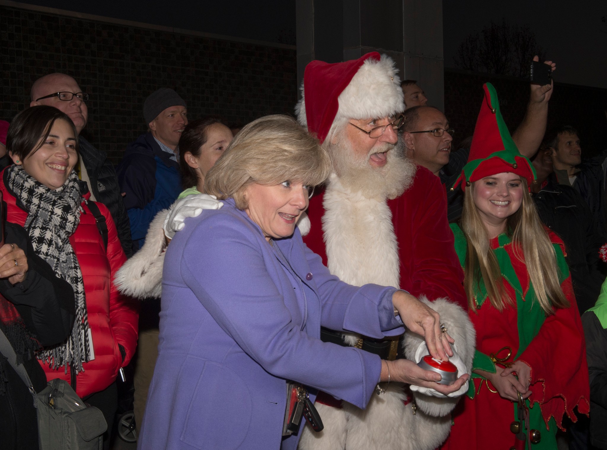Jody Singer, center, receives a helping hand from Santa Claus to officially light Marshall's holiday tree Dec. 1.