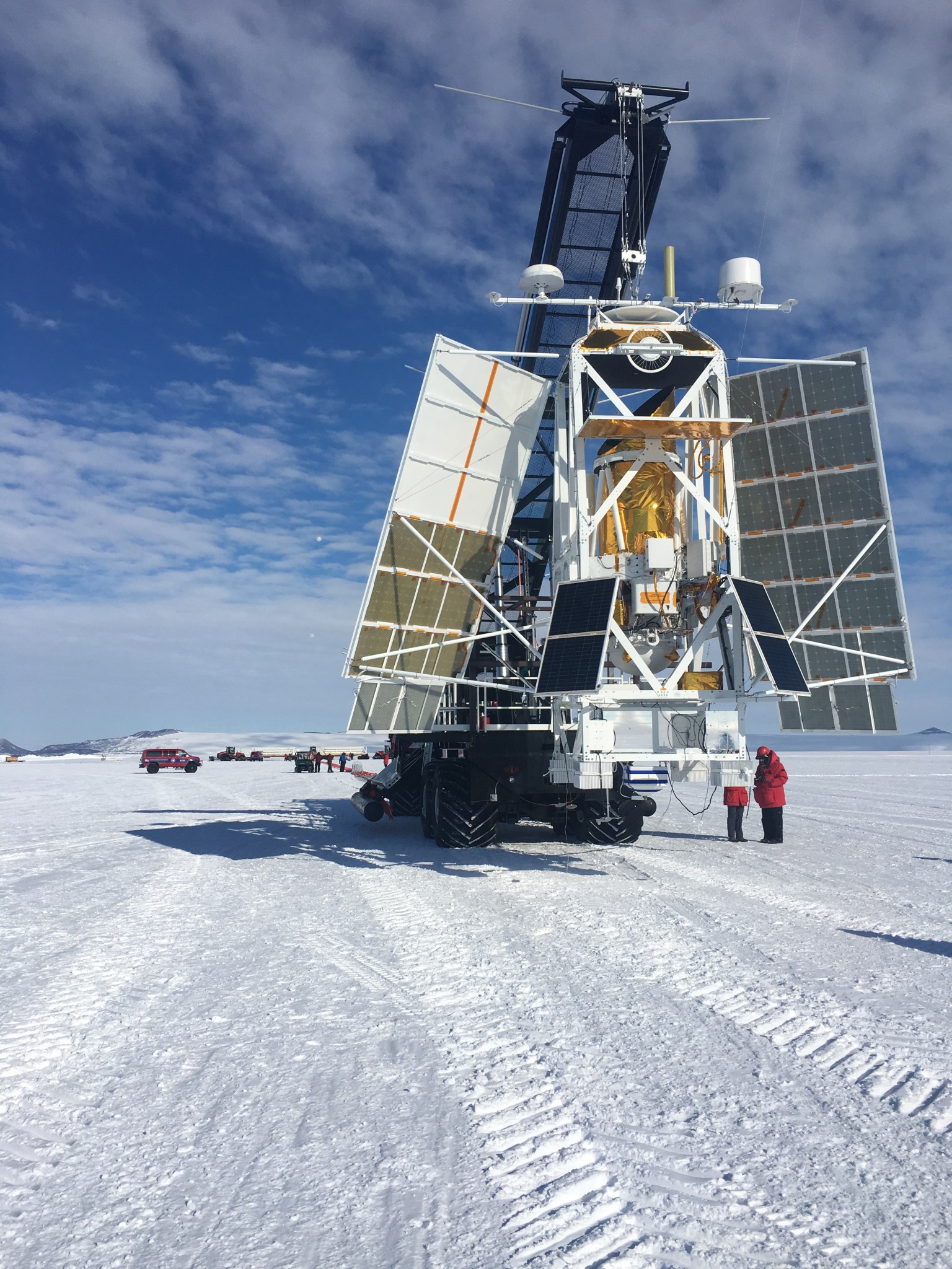 A large metal frame with various panels and instrumentation on a large trailer on the snow in Antarctica.