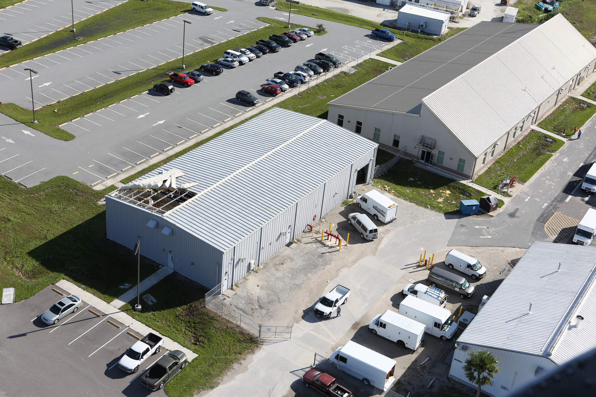 Damage to a facility roof is seen during an aerial survey of NASA's Kennedy Space Center in Florida on Oct. 8.