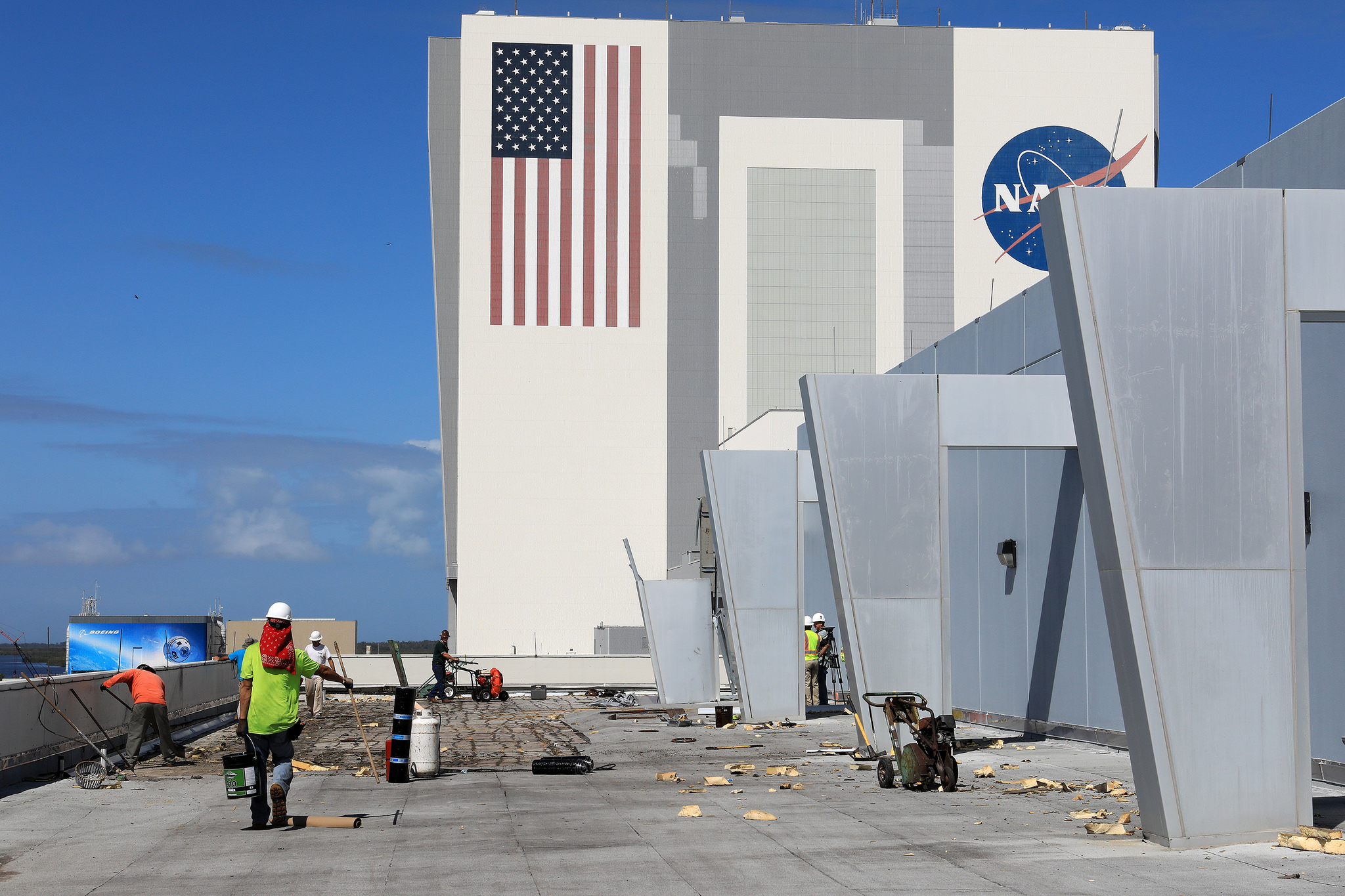 A section of roof is repaired atop Kennedy's Operations Support Building II following damage caused by Hurricane Matthew.