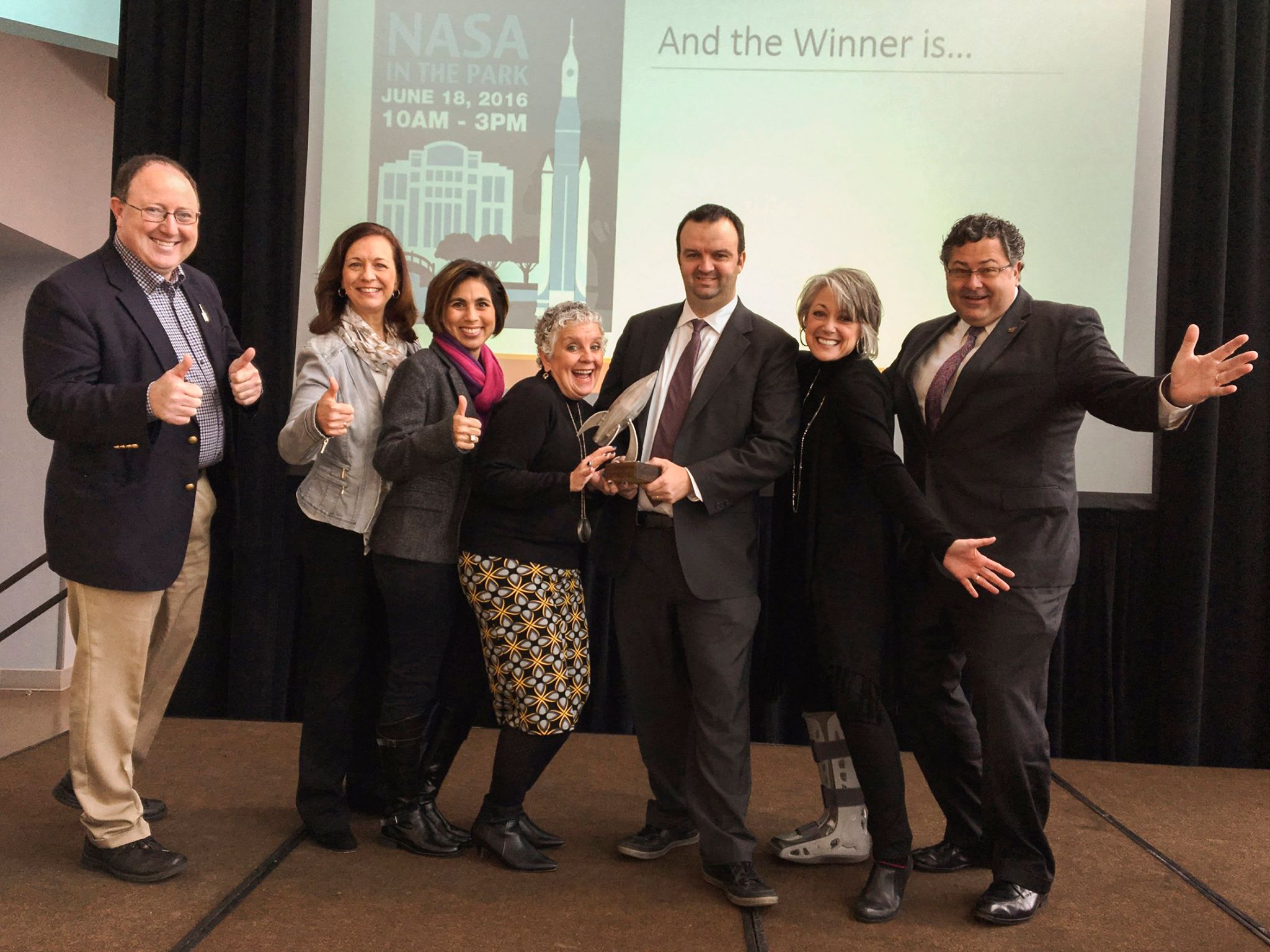 Chad Emerson,  left, presents the award for 2016 Event of the Year to officials from NASA's Marshall Space Flight Center.