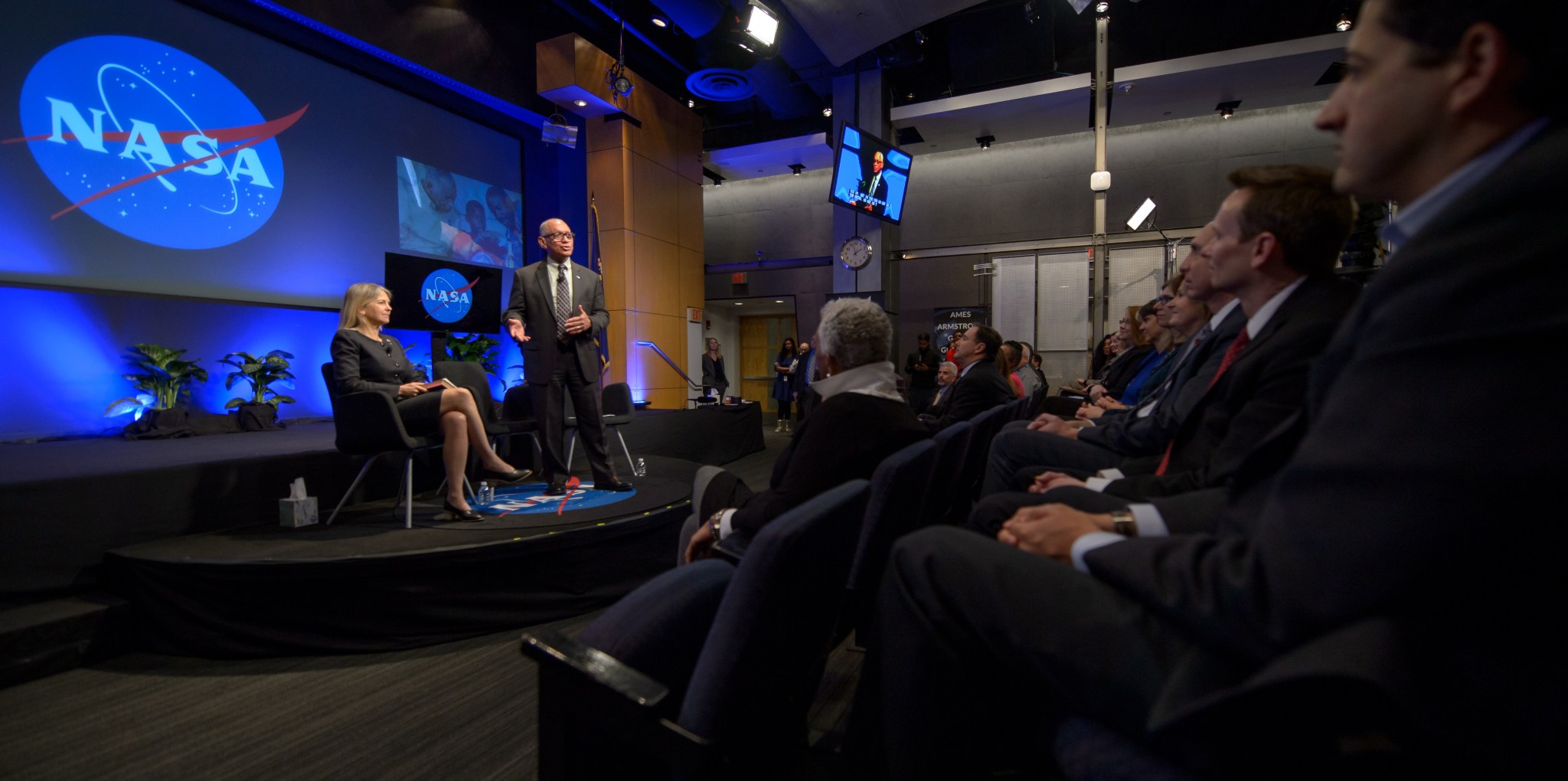 NASA Administrator Charles Bolden, standing, and Deputy Administrator Dava Newman, left, address employees at NASA Headquarters.