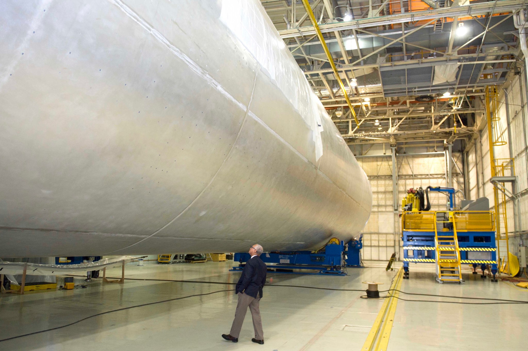 NASA Administrator Charles Bolden takes a walk around the huge liquid hydrogen tank of NASA's Space Launch System.