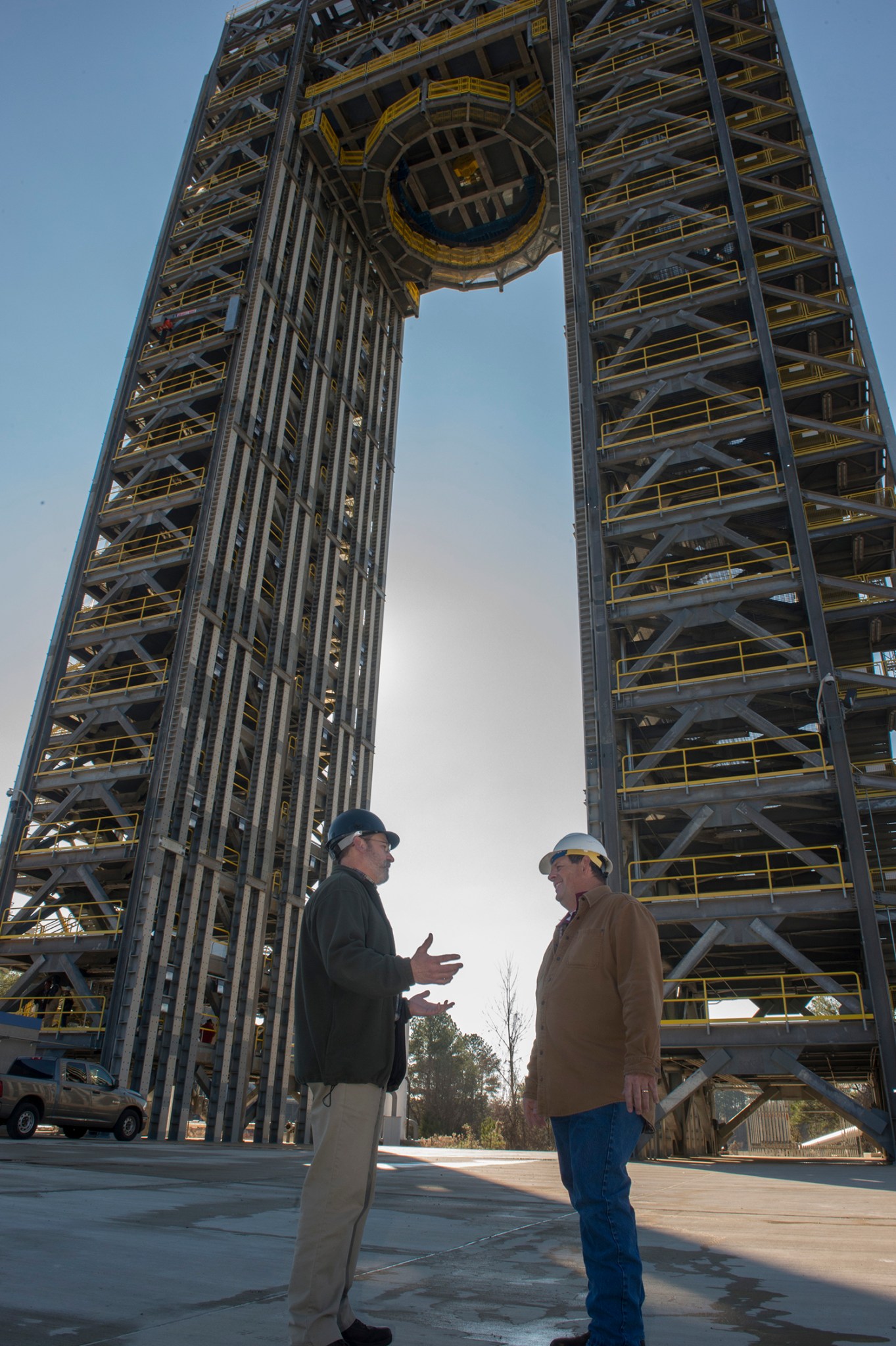 Robert Bobo, left, and Mike Nichols talk beneath the 221-foot-tall Test Stand 4693.