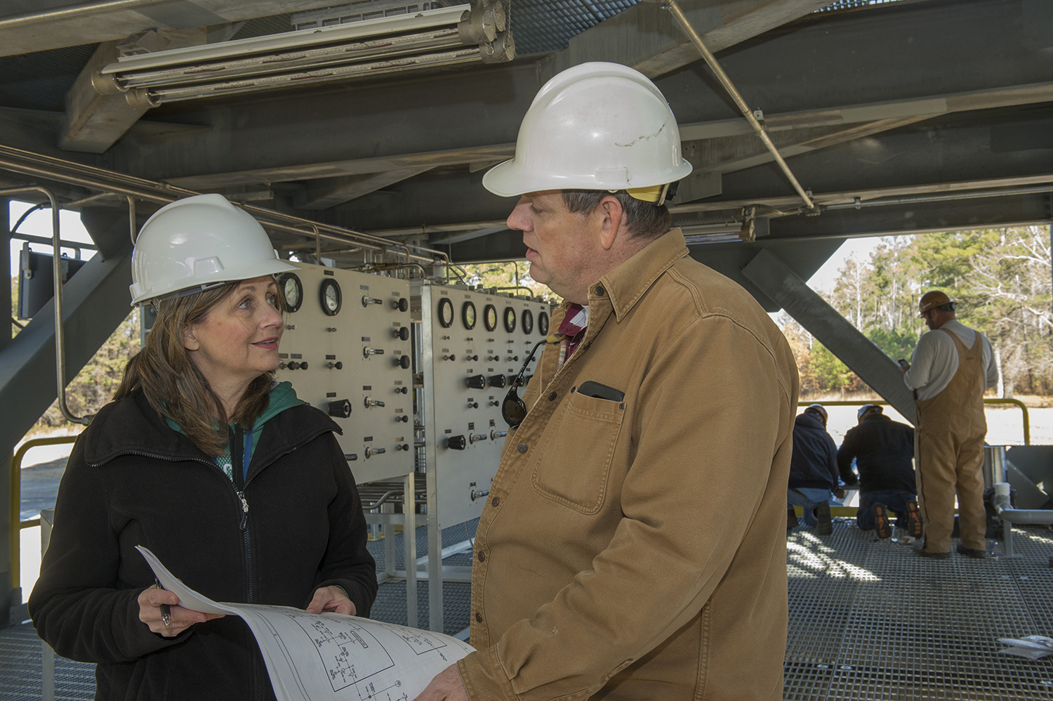Tara Marshall, left, talks about the installation of a pressurization control panel at Test Stand 4693 with Mike Nichols.