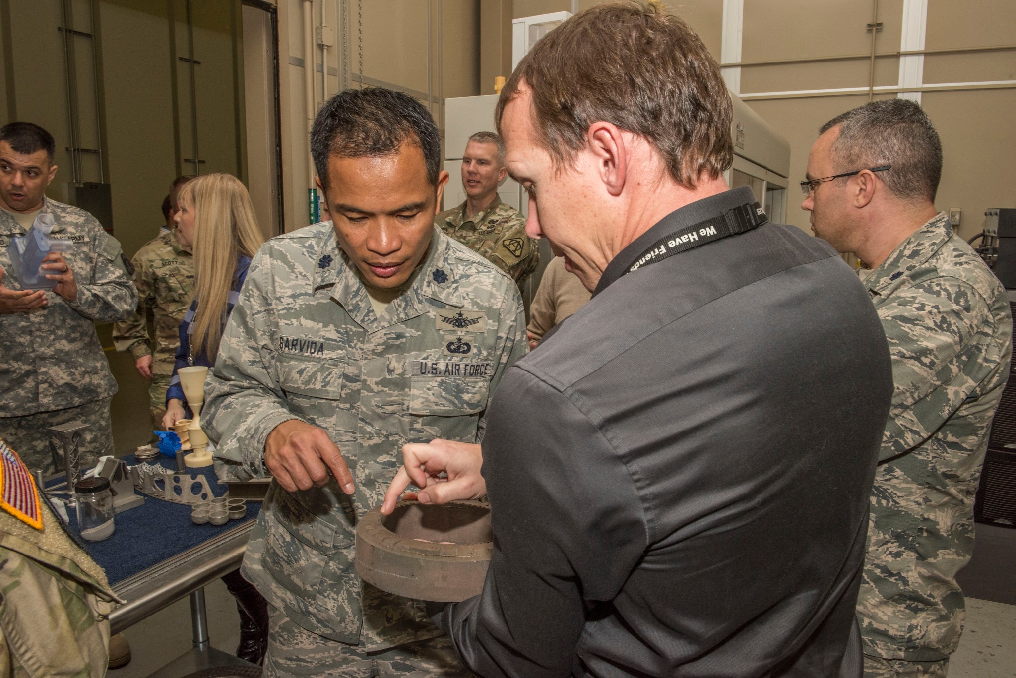 Members of the Missile Defense Agency on Redstone Arsenal visit with Brian West, front right, a structural materials engineer.