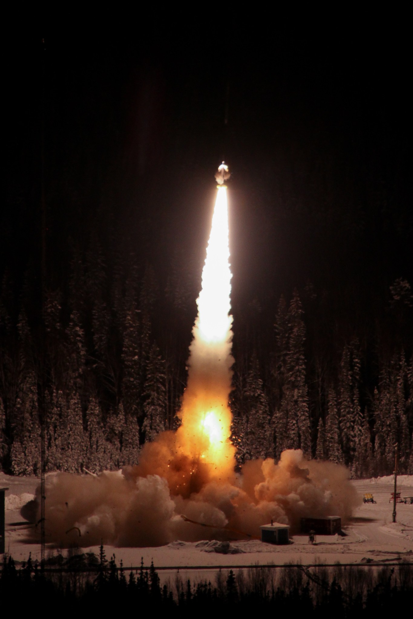 A nighttime photo of a sounding rocket launch in Alaska.