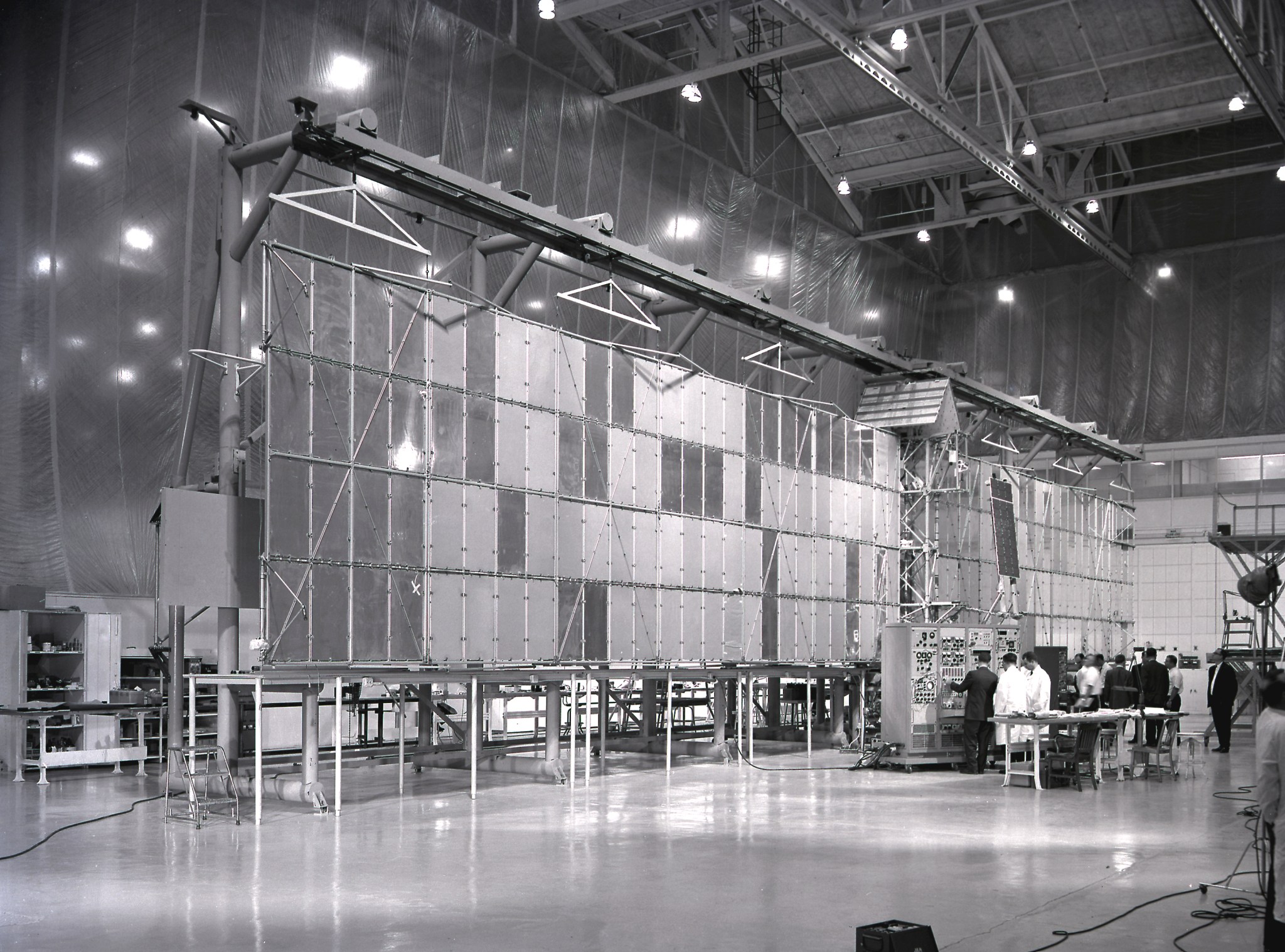 The massive Pegasus satellite is checked out by technicians.