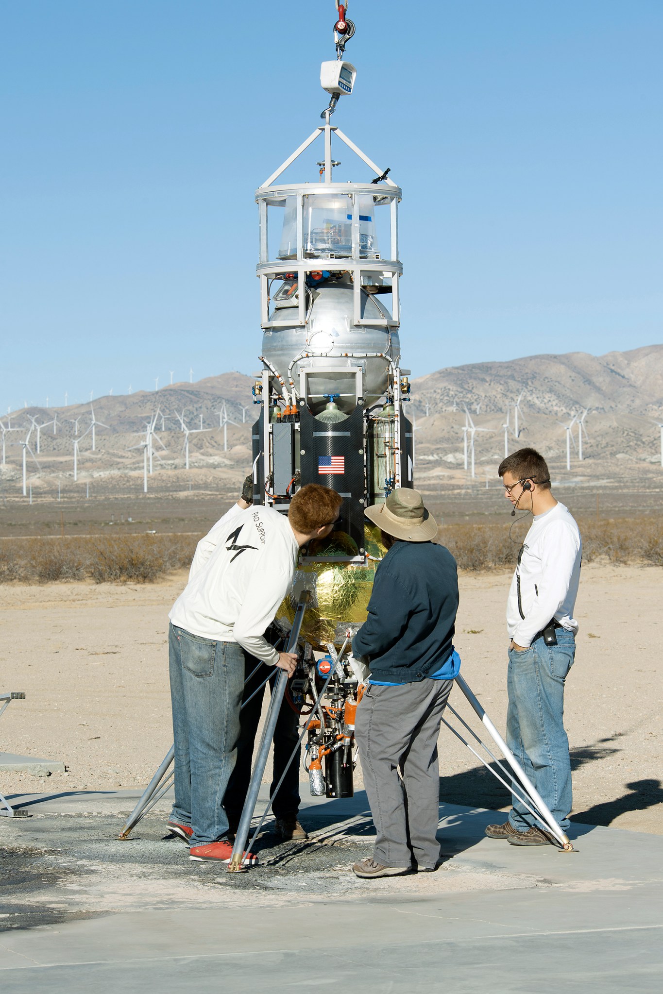 Masten employees repare Xodiac rocket to flight test JHU APL technology.