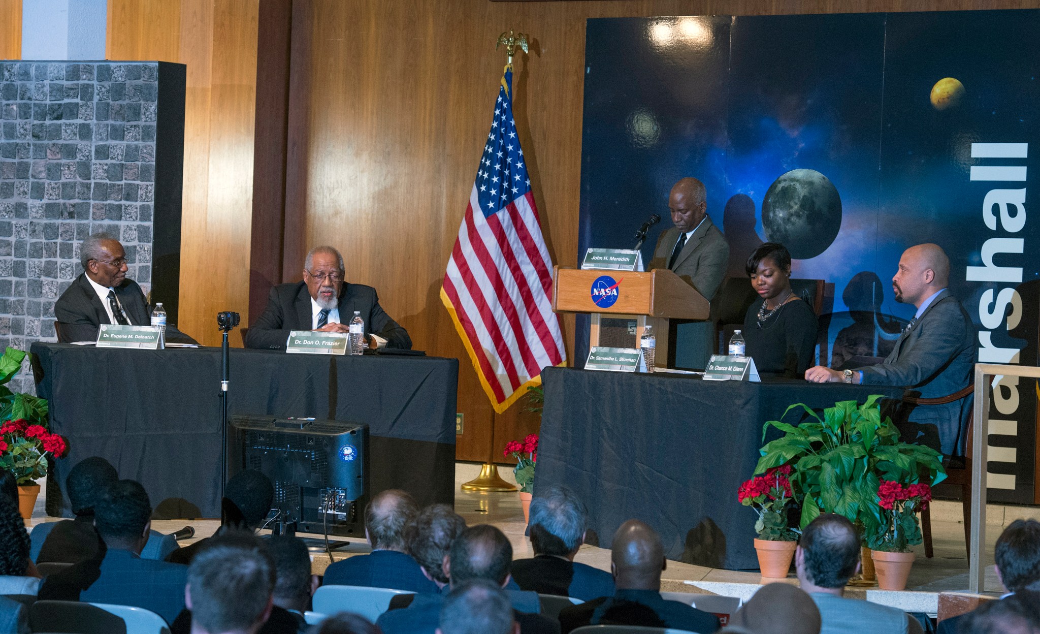 John Meredith, center, president and CEO of Meredith Advocacy, moderates a panel at NASA's Marshall Space Flight Center Feb. 16.