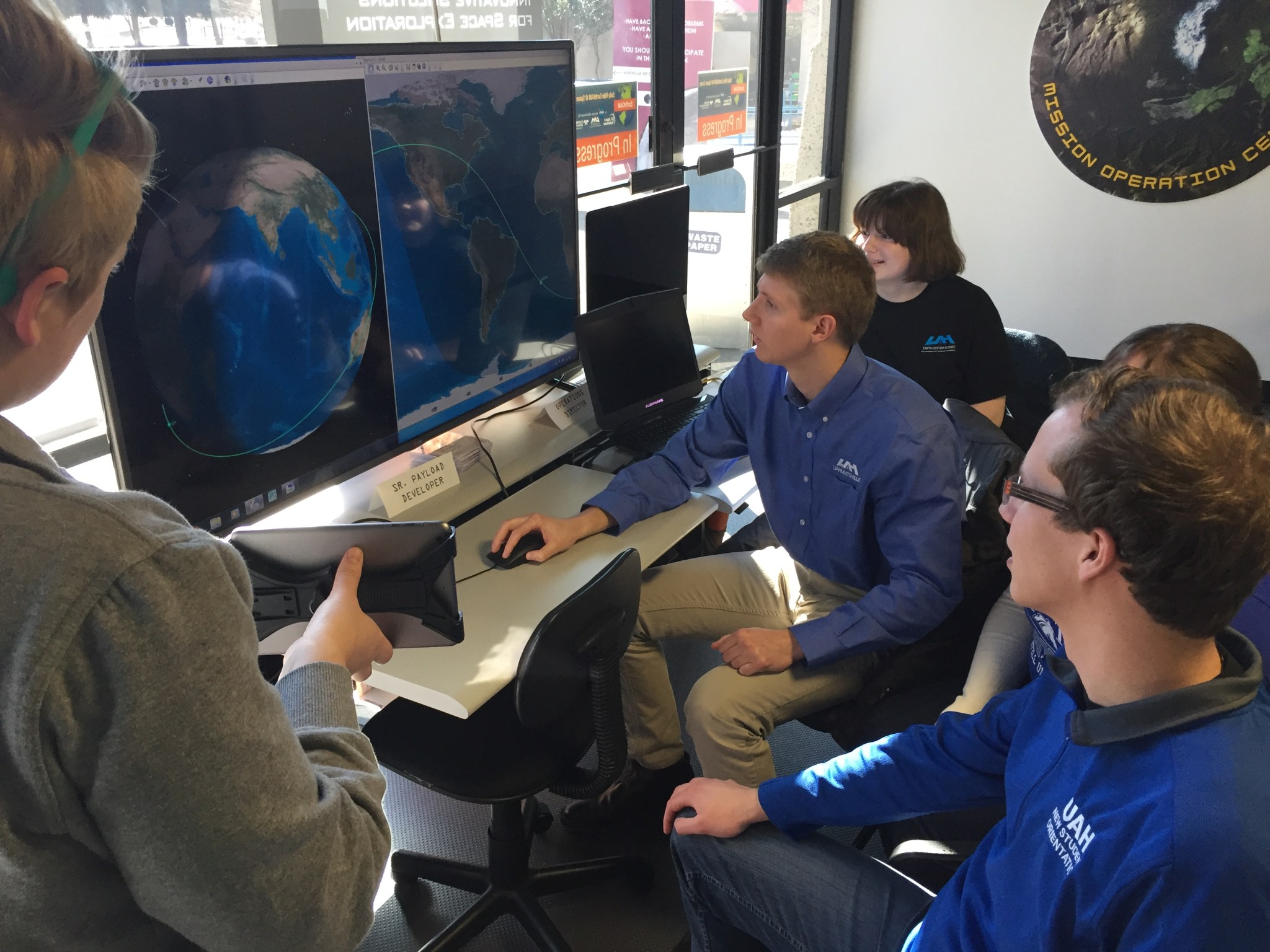 Students from the University of Alabama in Huntsville, who help manage the Sally Ride EarthKAM program, take questions.