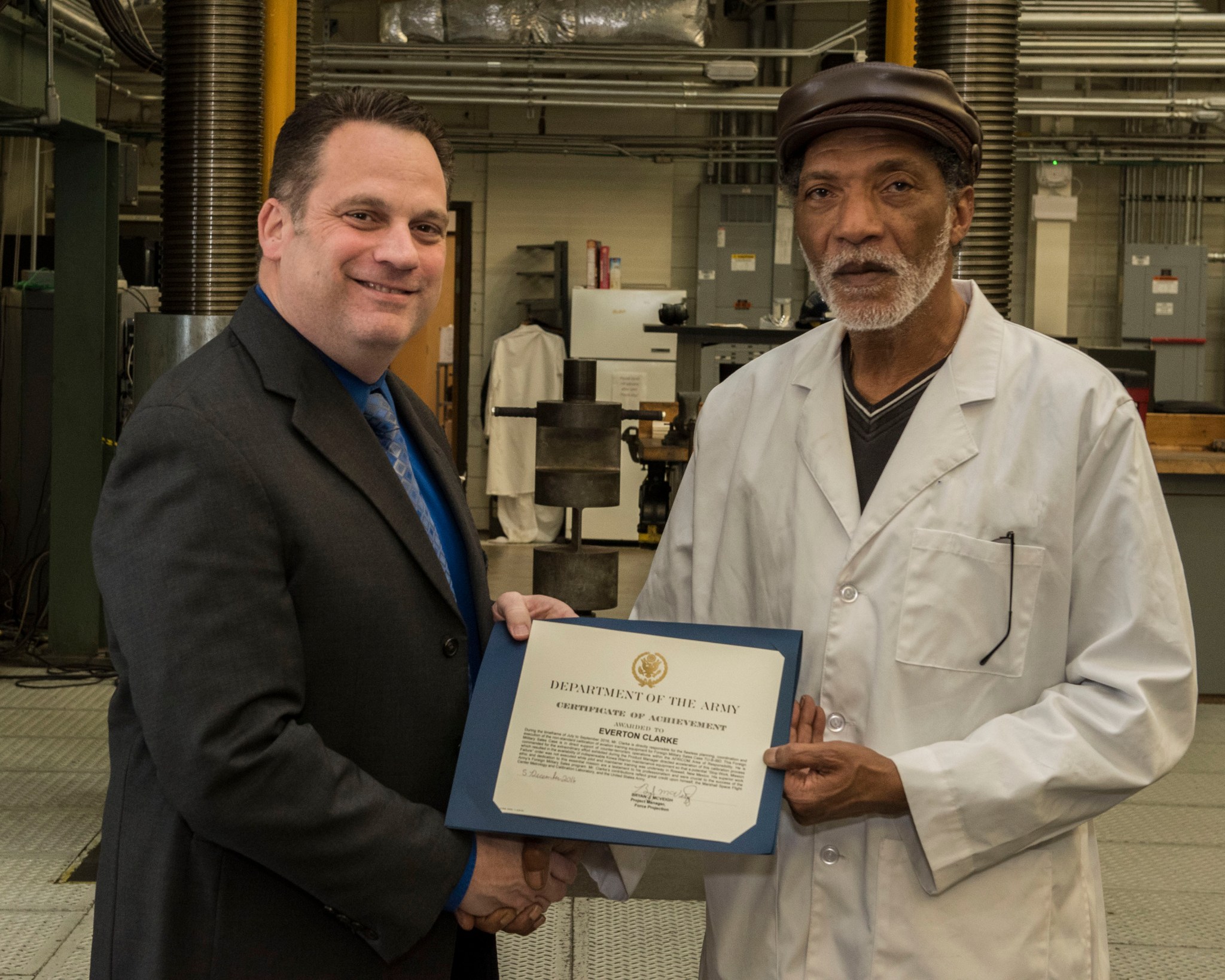Steve Roberts, left, U.S. Army Force Projection deputy program manager, and Metrology technician Everton Clarke.