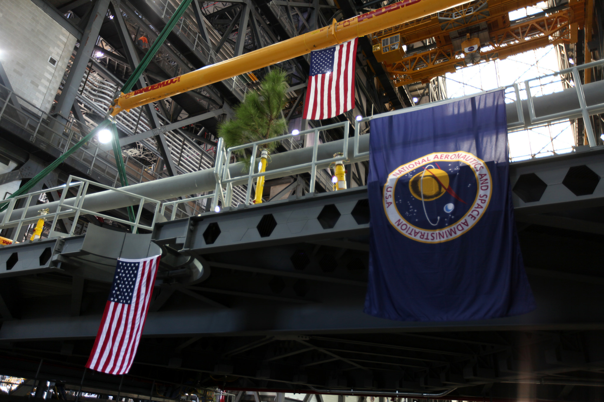 The American flag is in view on the final work platform, A north, as it the platform is lifted for installation in the VAB.