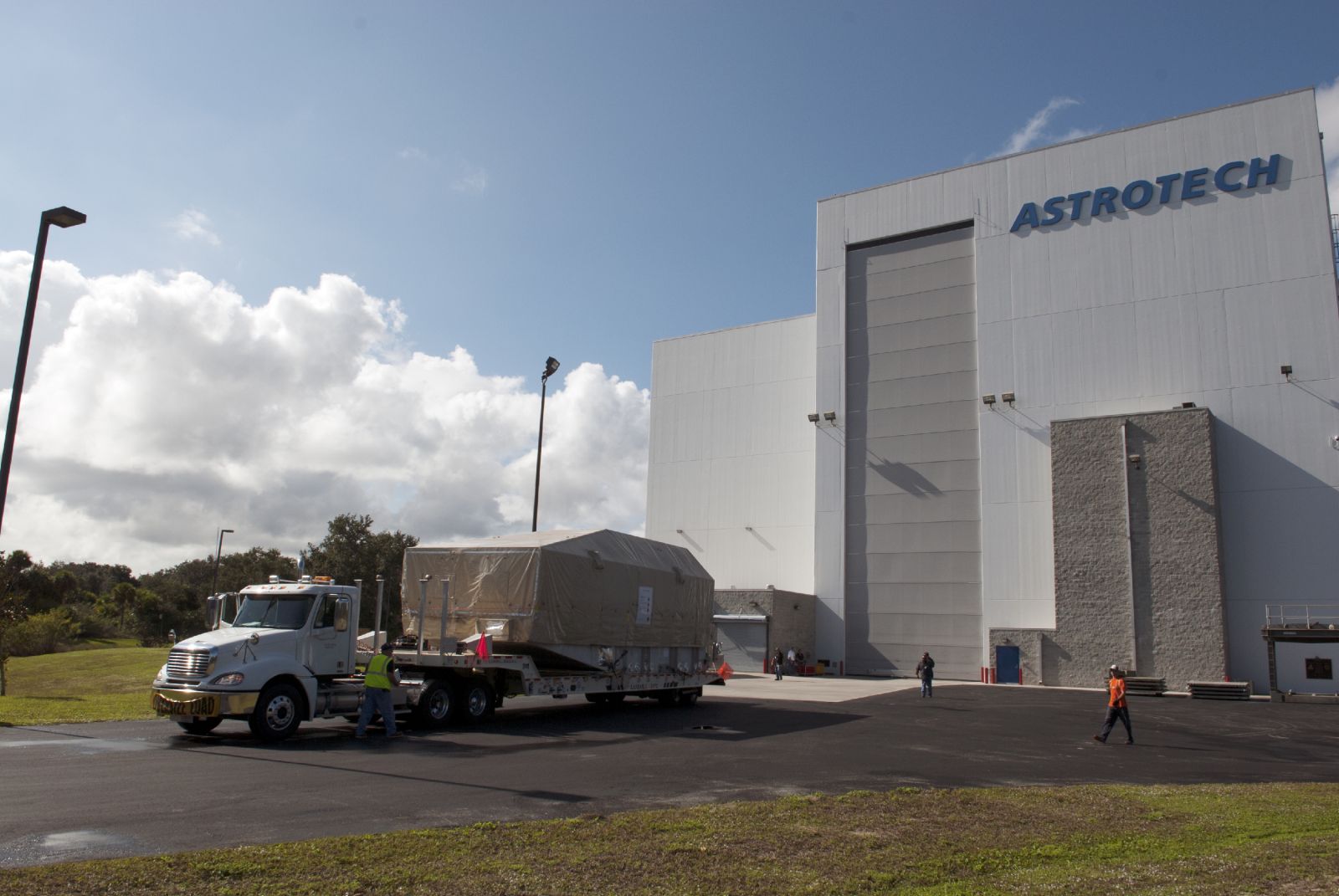 A truck hauls NASA's TDRS-L satellite to the Astrotech facility in Titusville