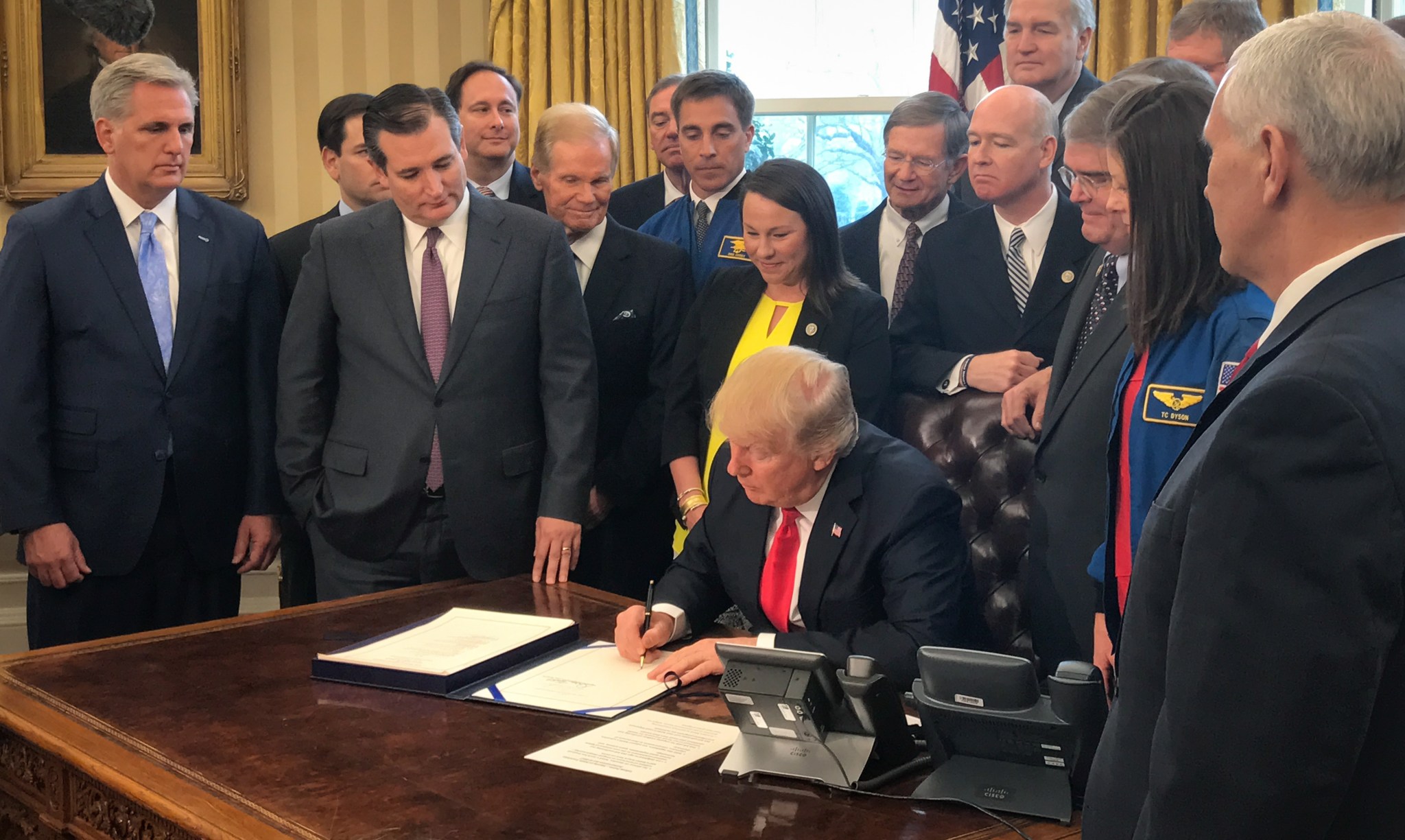 President Donald Trump signs NASA authorization act alongside NASA officials and members of Congress