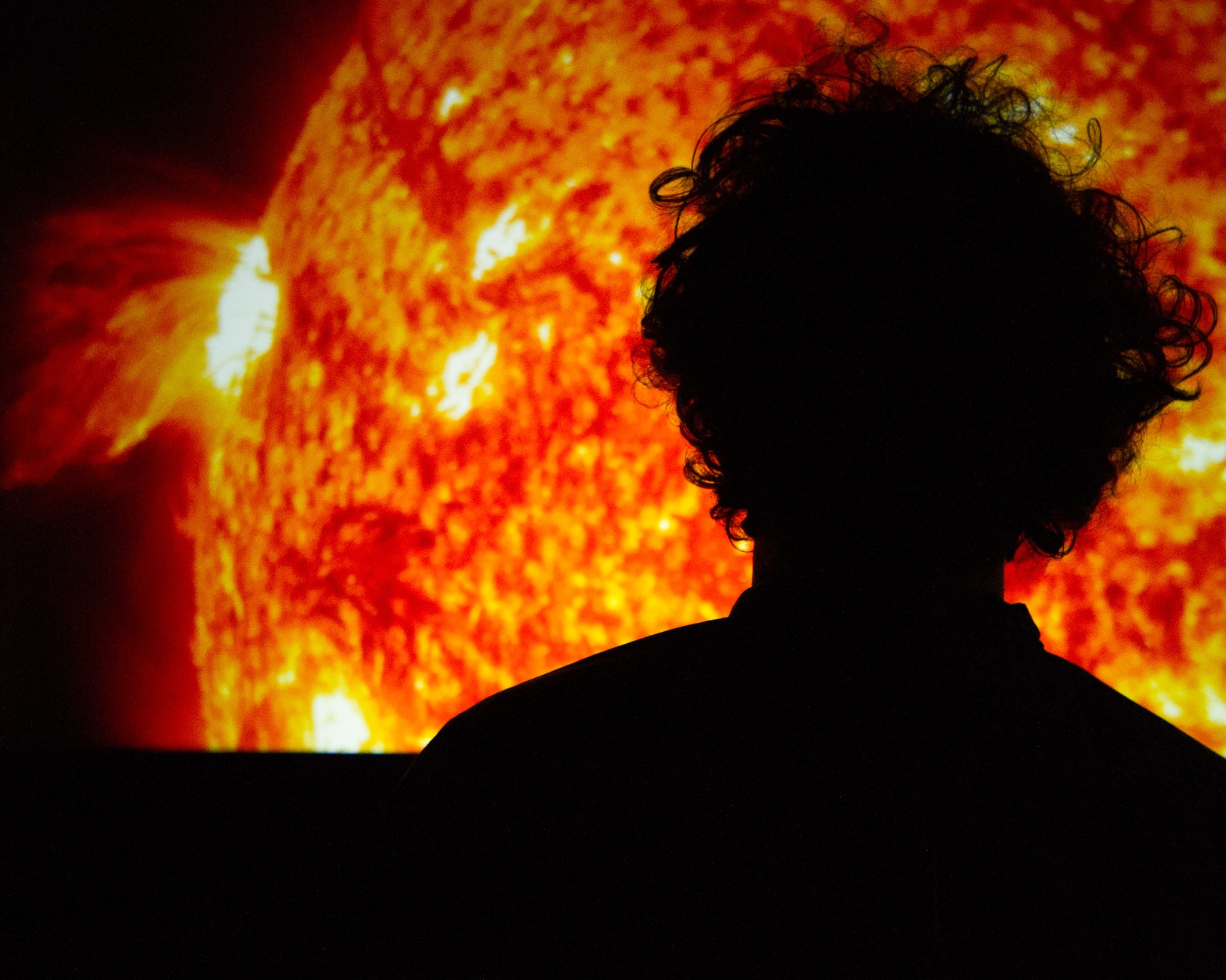 silhouette of Solarium exhibit attendee viewing image of the sun