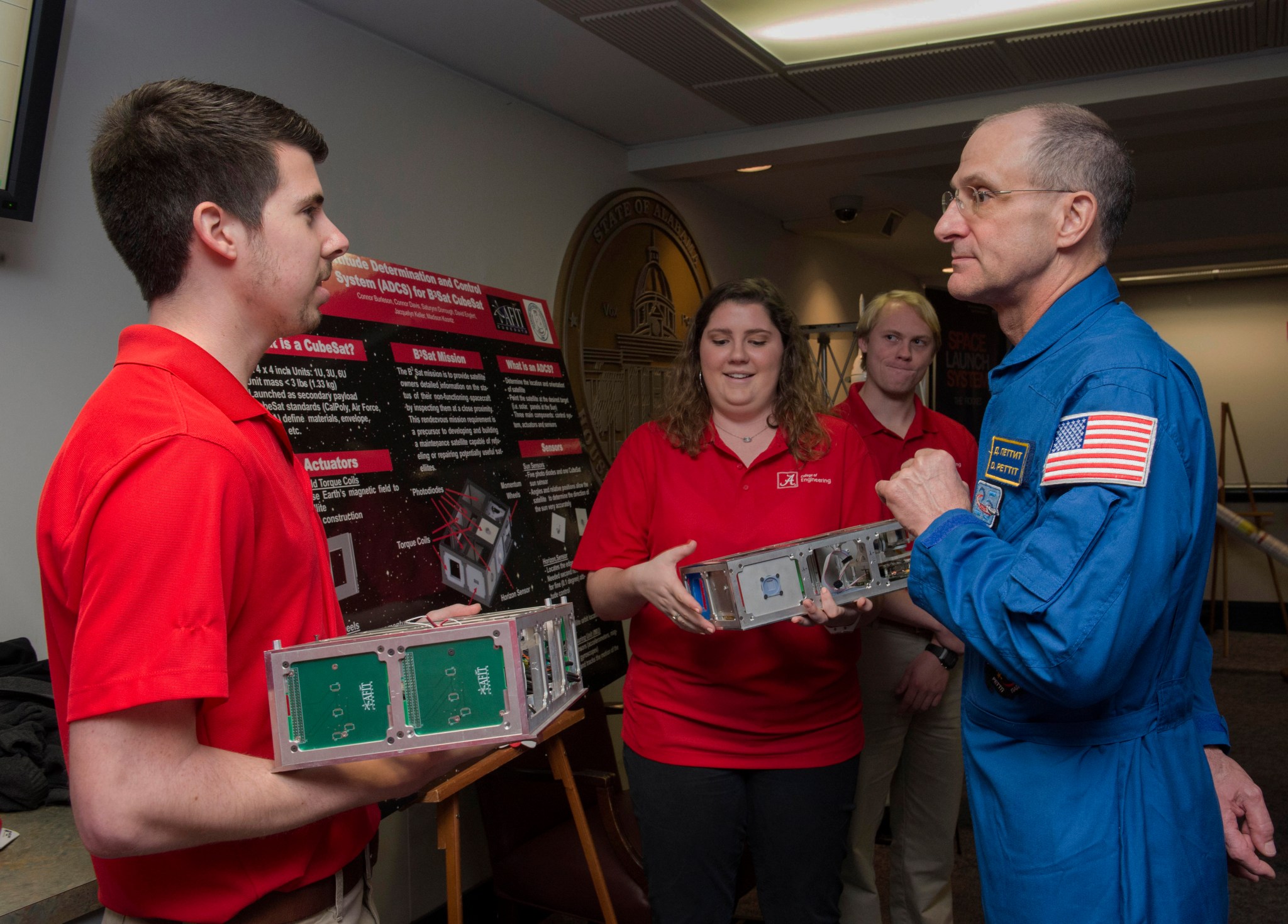 : NASA astronaut Don Pettit, right, a veteran of three spaceflights, discusses CubeSat technology with students.