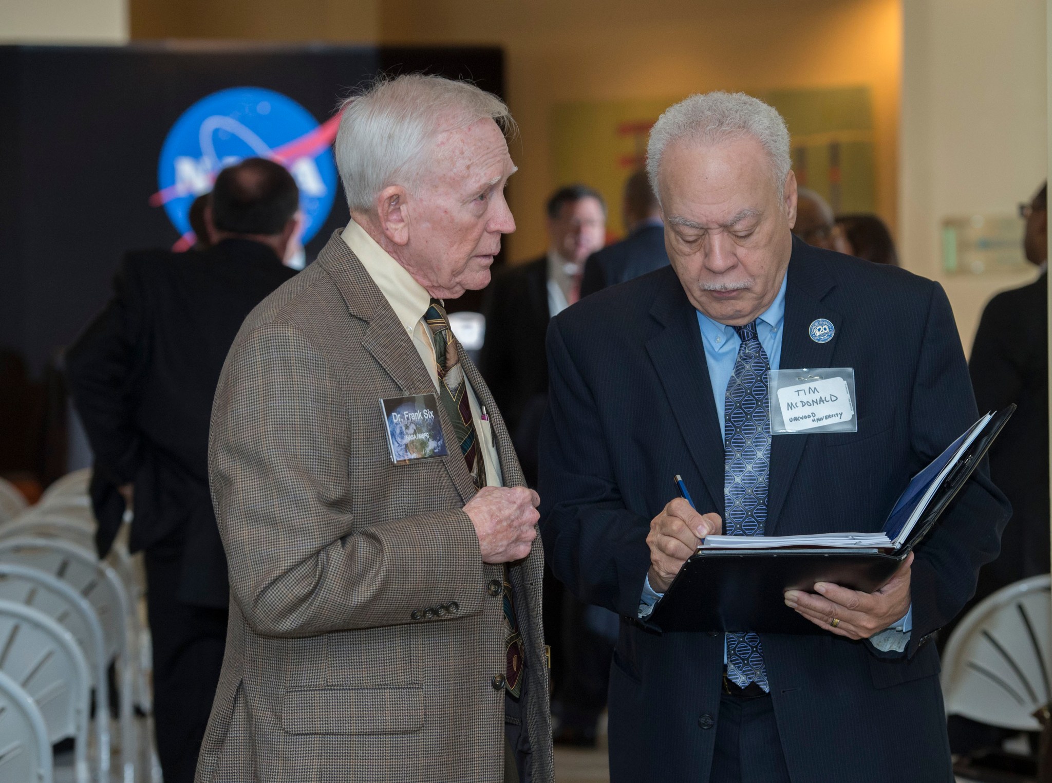 Frank Six, left, talks with Tim McDonald.