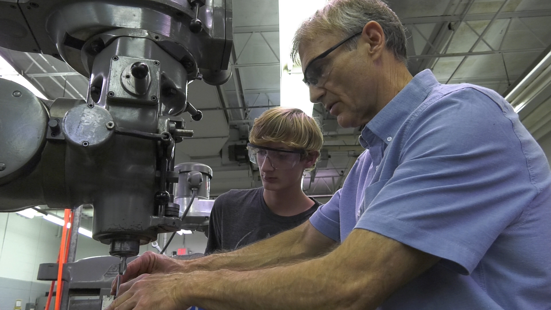 Bill Gibson, right, works through the finer points of running a milling machine with Jackson Hanley.