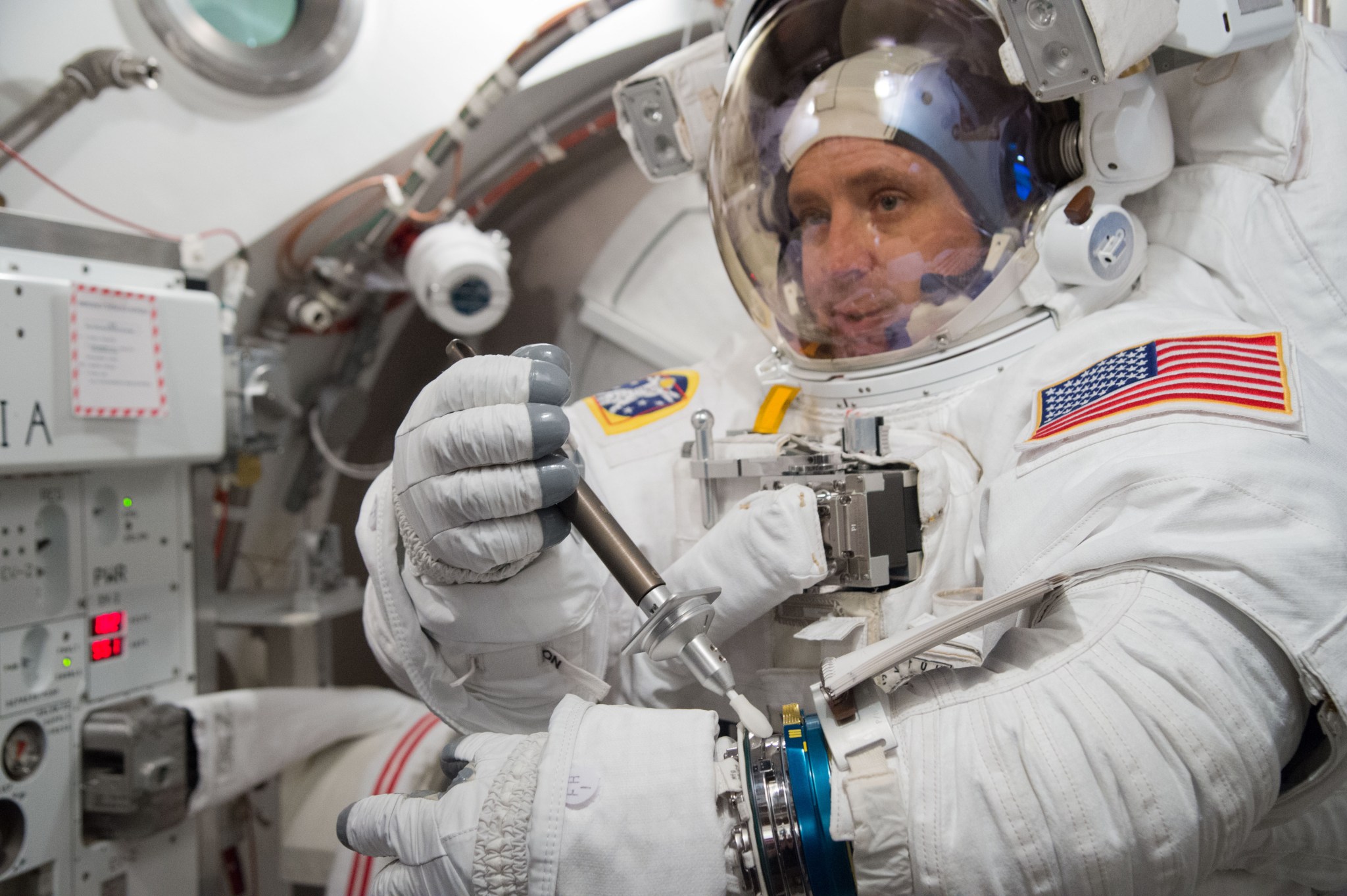 Jack Fischer, Expedition 51/52 crew member, training in the Extravehicular Mobility Unit in the Space Station Airlock Test