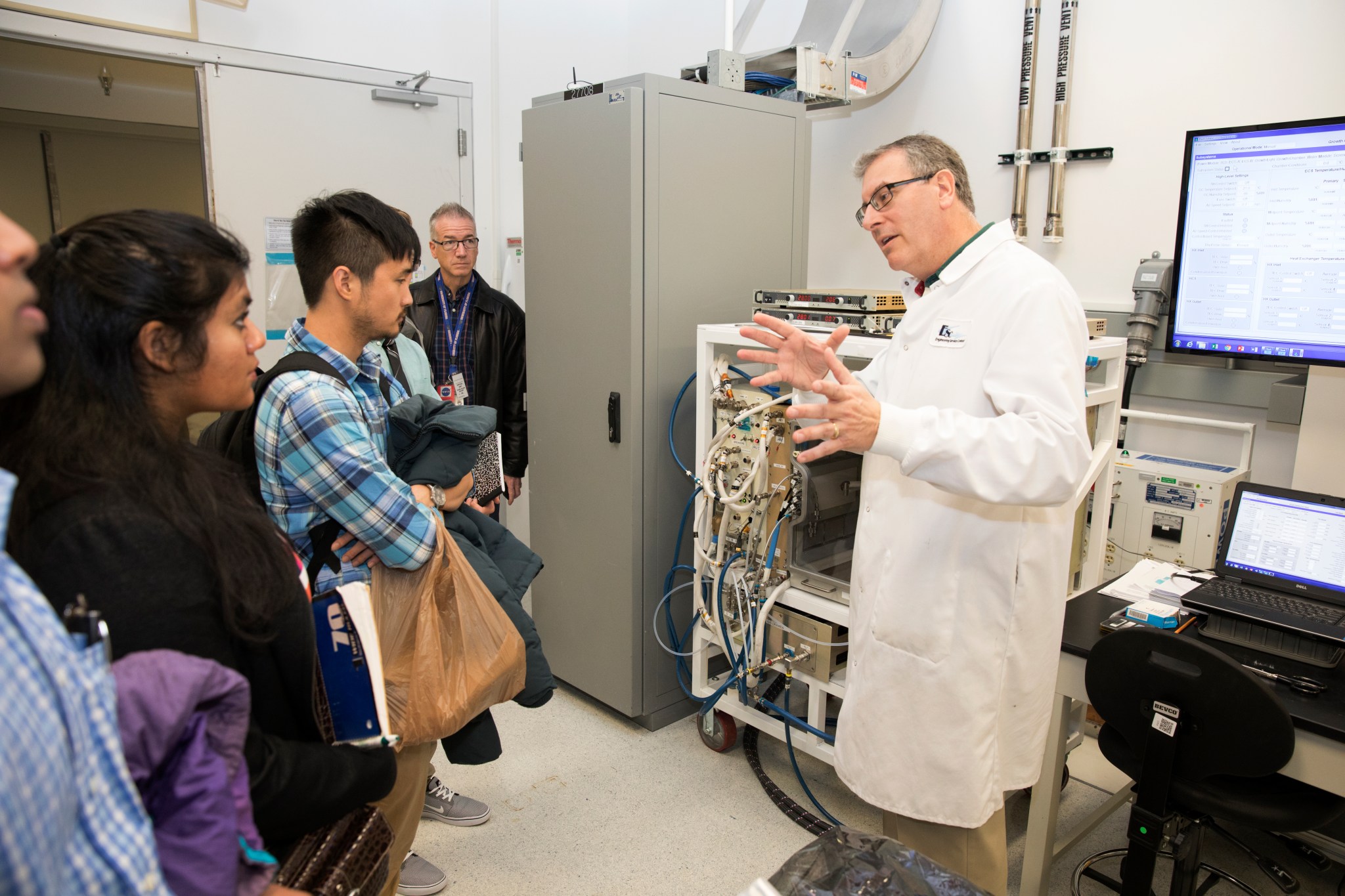 Students listen as a NASA engineer describes his work